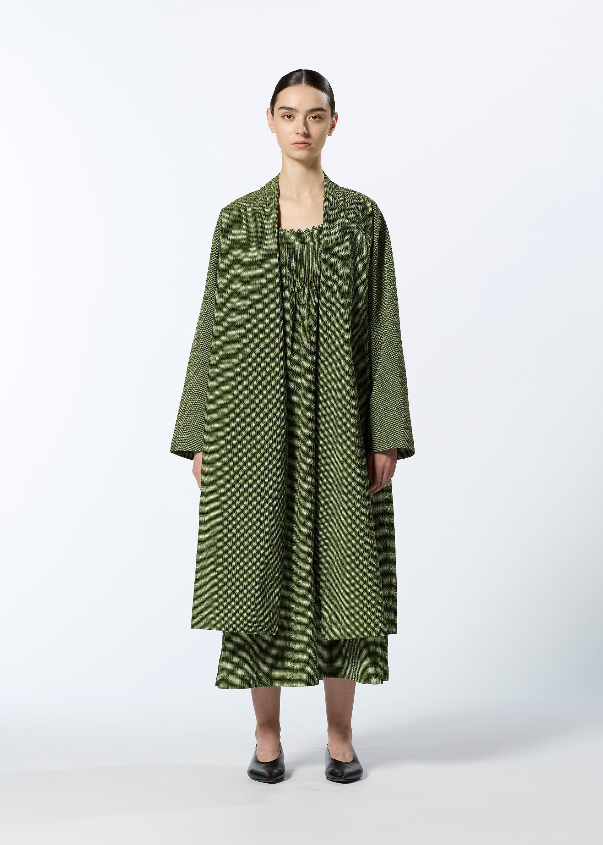 A model wears the HAAT LIGHT WEIGHT cardigan.