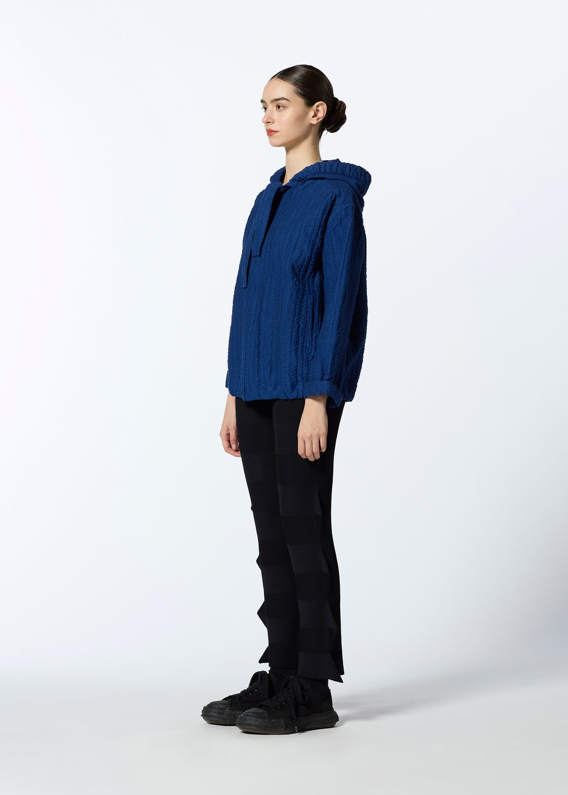 A model wears the HAAT RASCHEL ASSEMBLY cardigan.