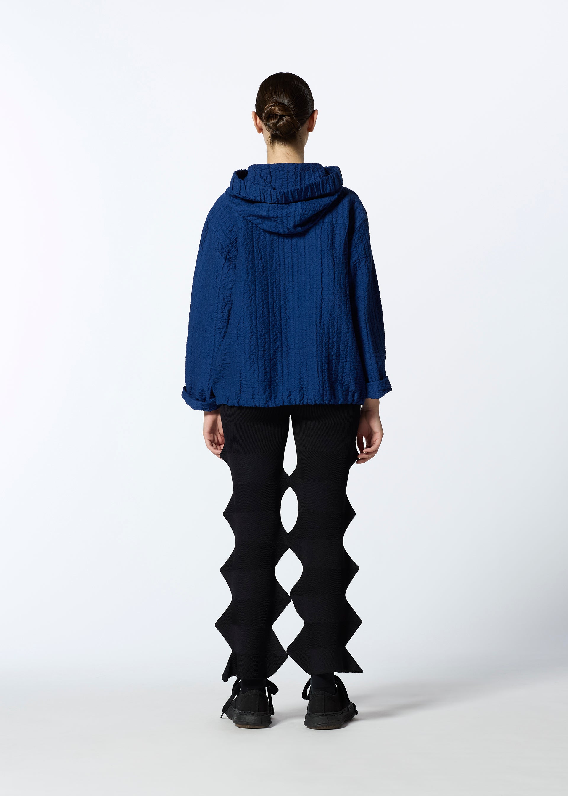 A model wears the HAAT RASCHEL ASSEMBLY cardigan.