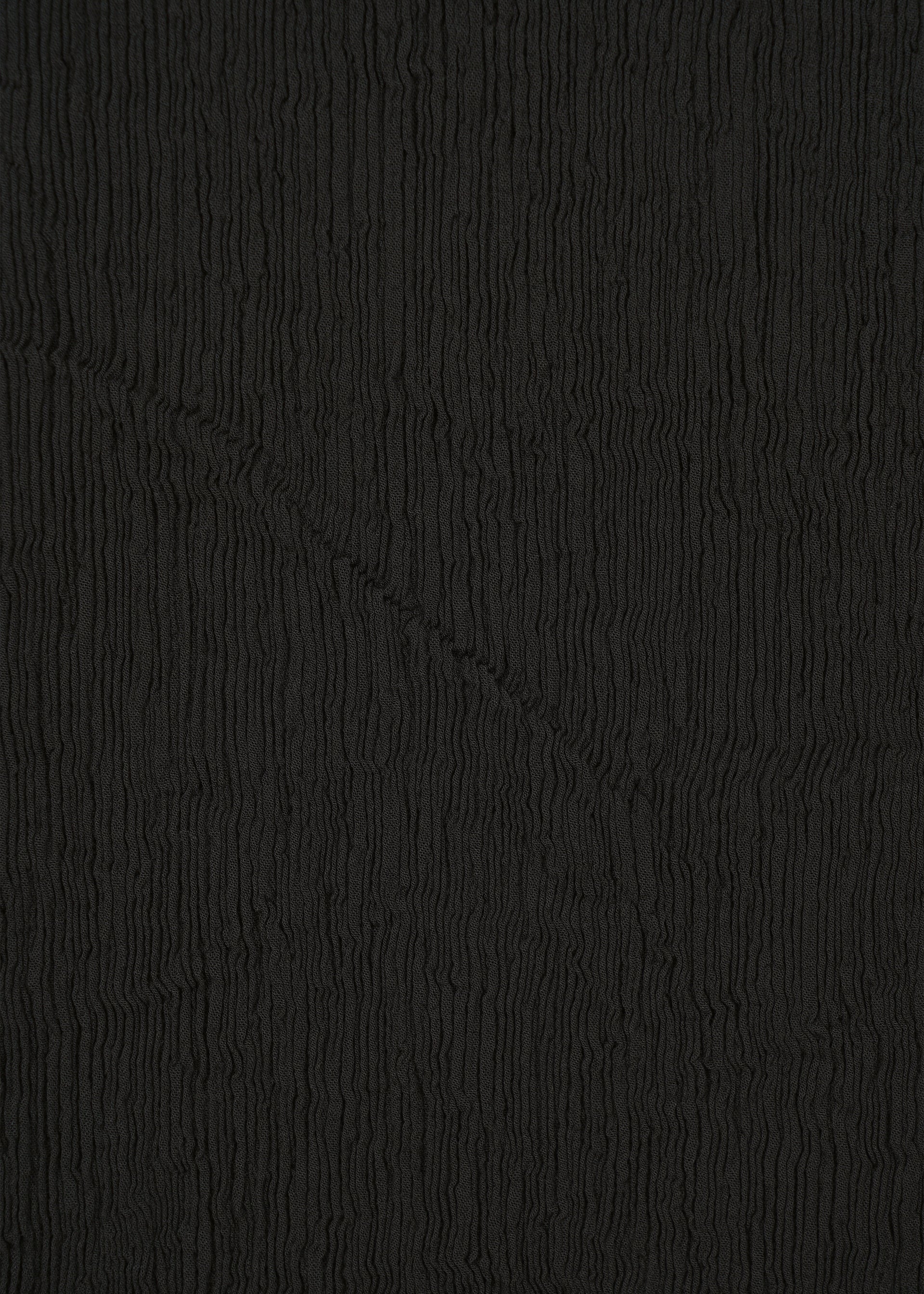 A detail shot of the HAAT KYO CHIJIMI BASIC trousers