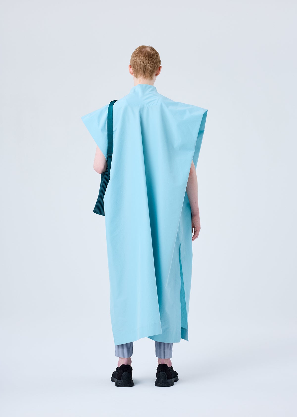 A model wears the HOMME PLISSÉ ISSEY MIYAKE UTILITY bag