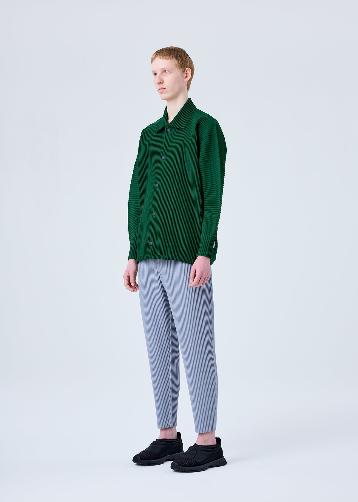 A model wears the HOMME PLISSÉ ISSEY MIYAKE MC AUGUST jacket