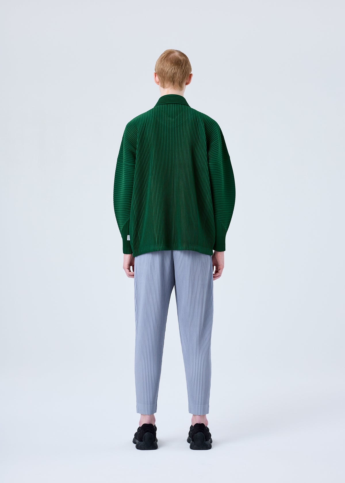 A model wears the HOMME PLISSÉ ISSEY MIYAKE MC AUGUST jacket