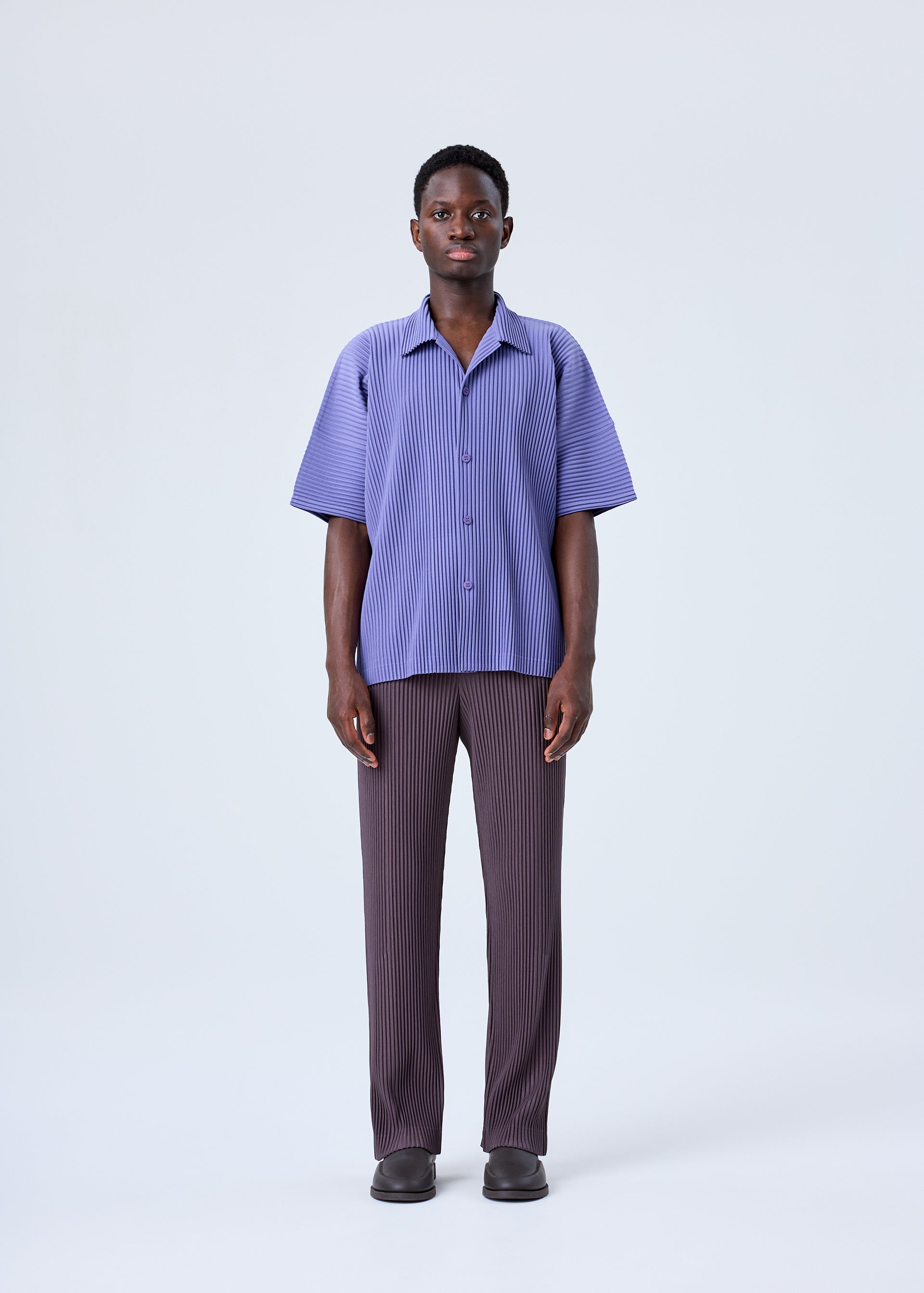 A model wears the HOMME PLISSÉ ISSEY MIYAKE MC JULY shirt