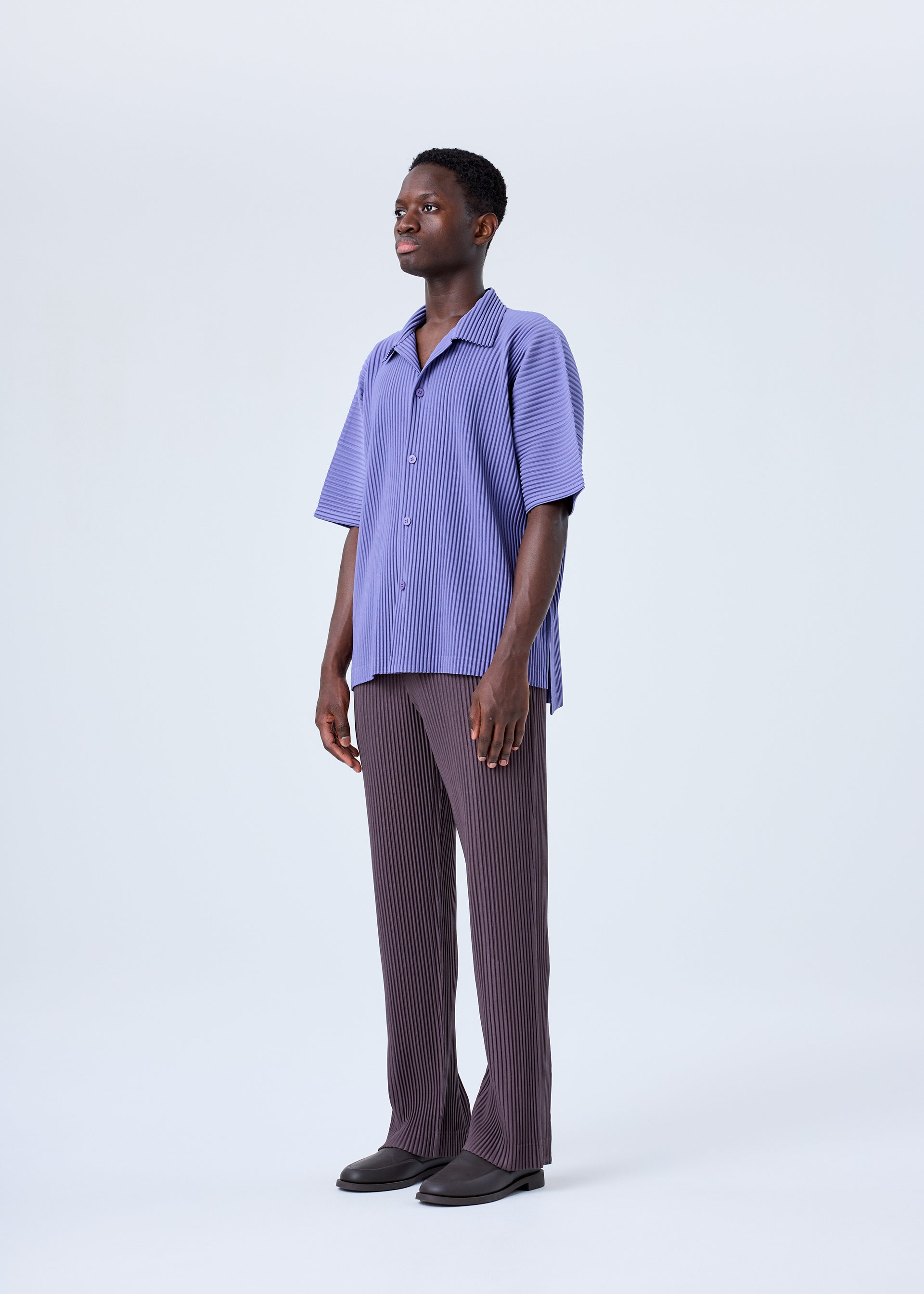 A model wears the HOMME PLISSÉ ISSEY MIYAKE MC JULY shirt