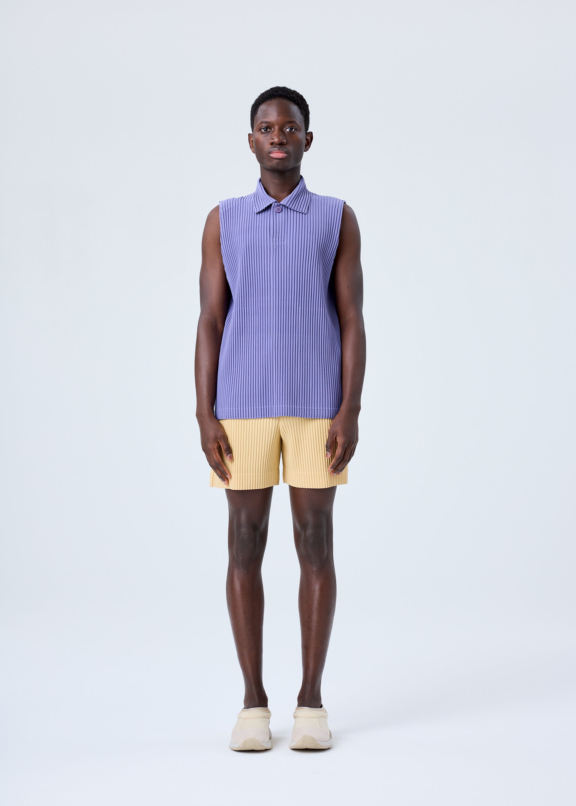 A model wears the HOMME PLISSÉ ISSEY MIYAKE MC JULY shirt