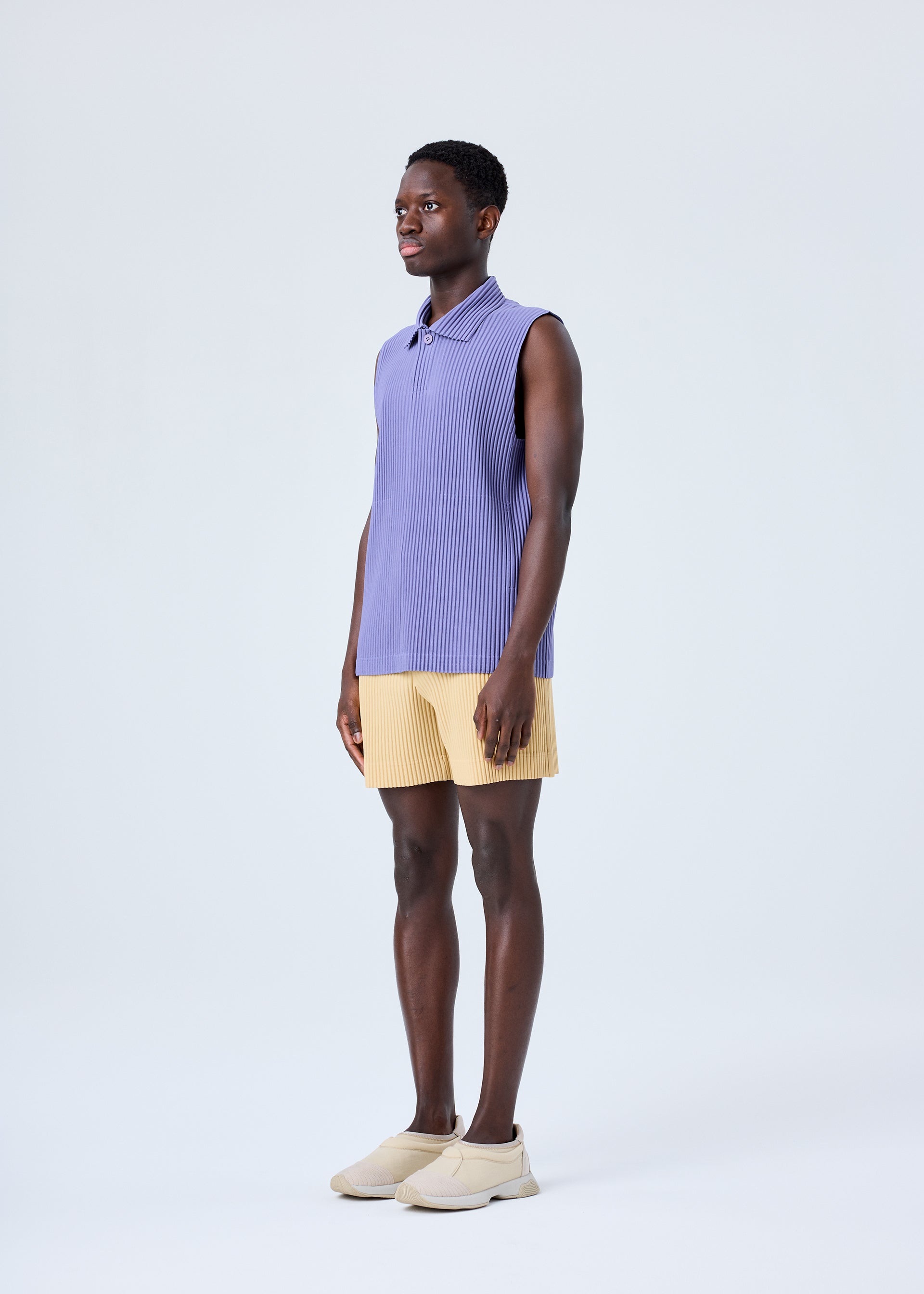 A model wears the HOMME PLISSÉ ISSEY MIYAKE MC JULY shirt