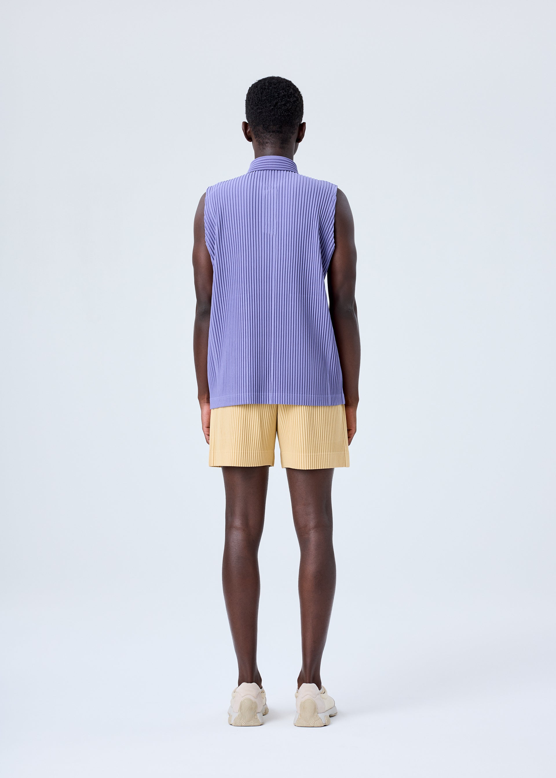 A model wears the HOMME PLISSÉ ISSEY MIYAKE MC JULY shirt