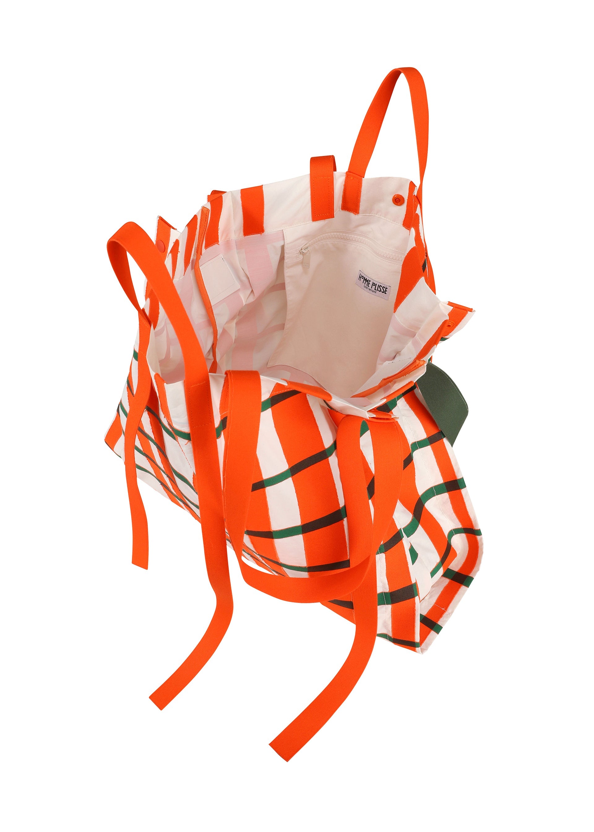 A detail shot of the HOMME PLISSÉ ISSEY MIYAKE WINDSWEPT PLAID BAG bag.