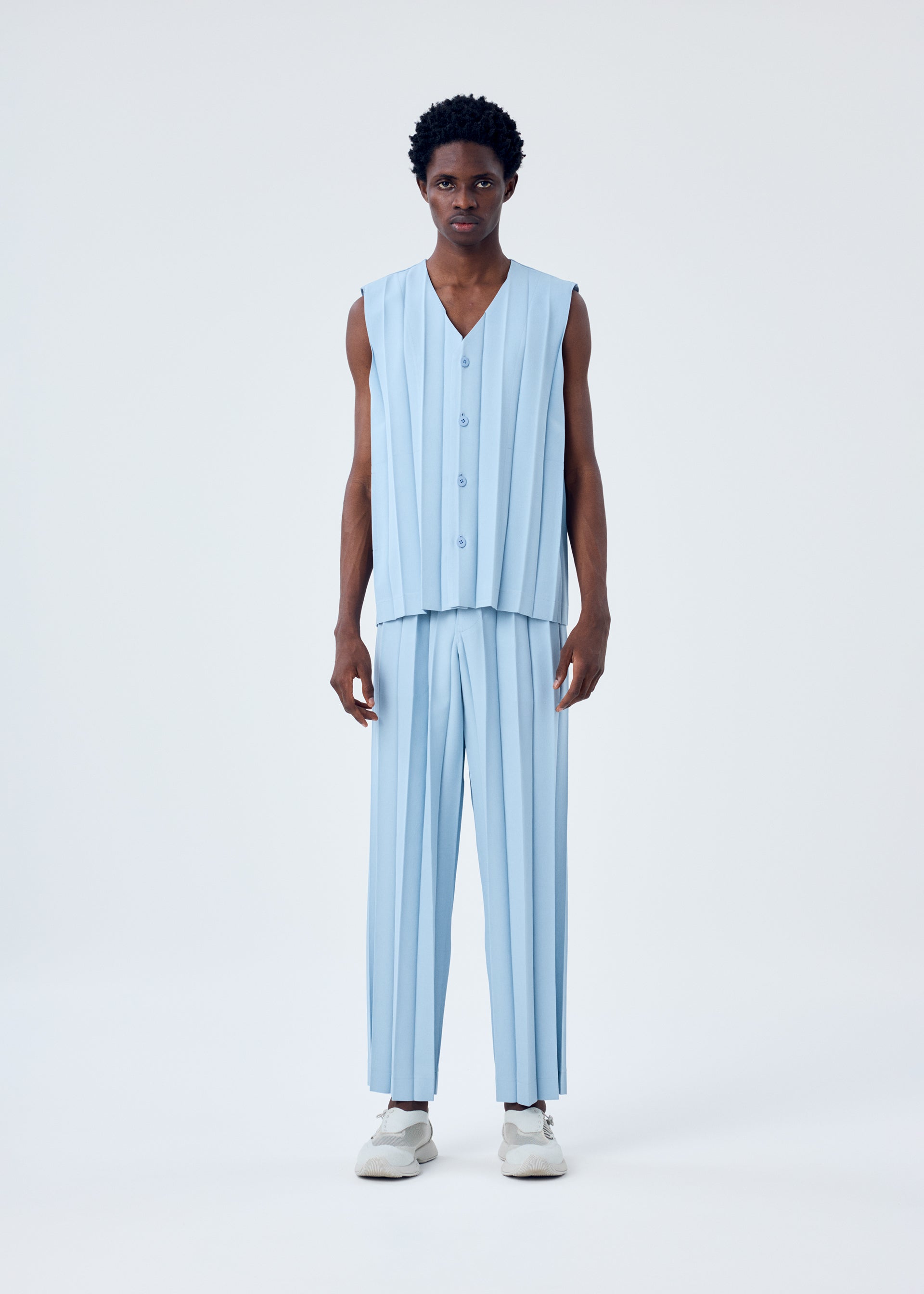 A model wears the HOMME PLISSÉ ISSEY MIYAKE EDGE ENSEMBLE vest.
