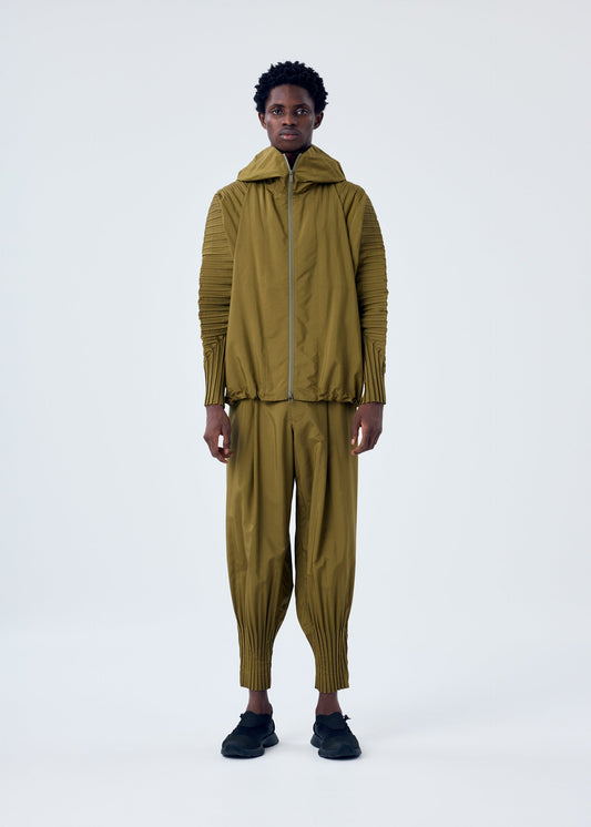 A model wears the HOMME PLISSÉ ISSEY MIYAKE CASCADE trousers.