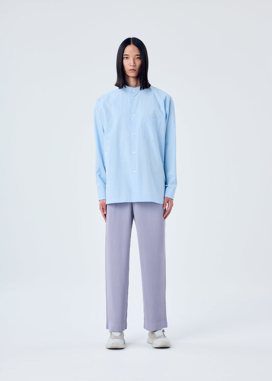 A model wears the HOMME PLISSÉ ISSEY MIYAKE STREAMLINE SHIRT shirt.