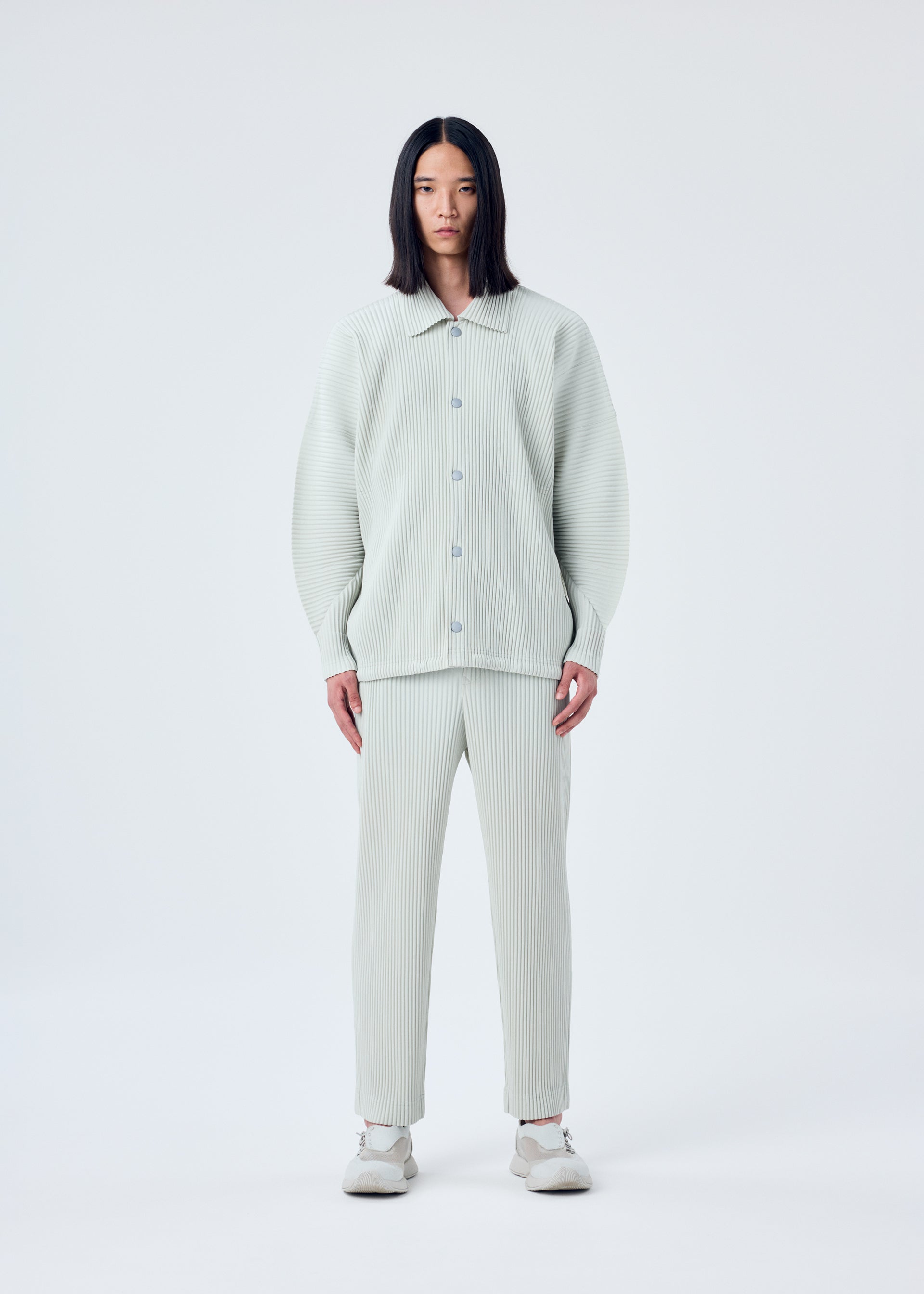 A model wears the HOMME PLISSÉ ISSEY MIYAKE MC MARCH jacket.