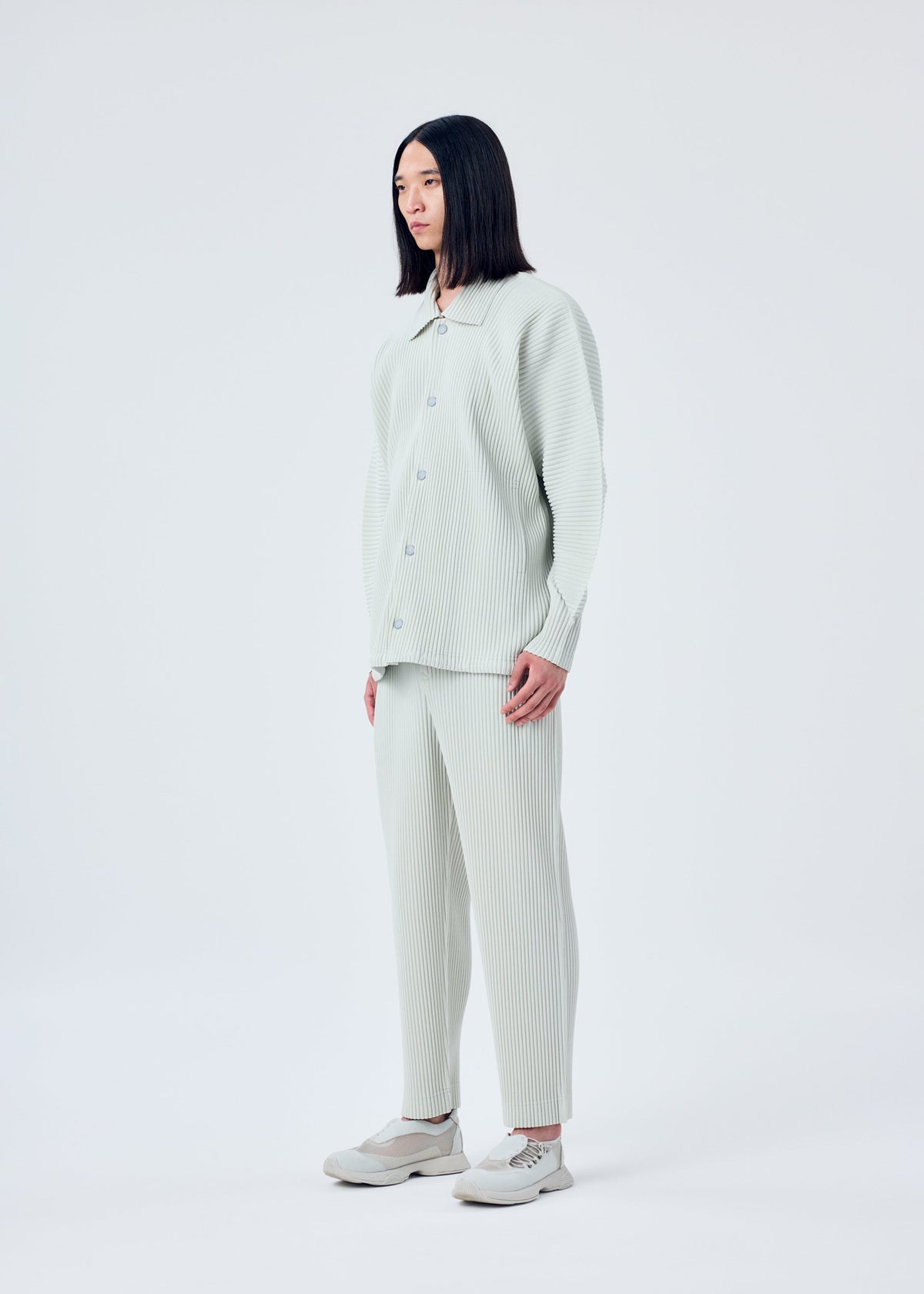 A model wears the HOMME PLISSÉ ISSEY MIYAKE MC MARCH jacket.