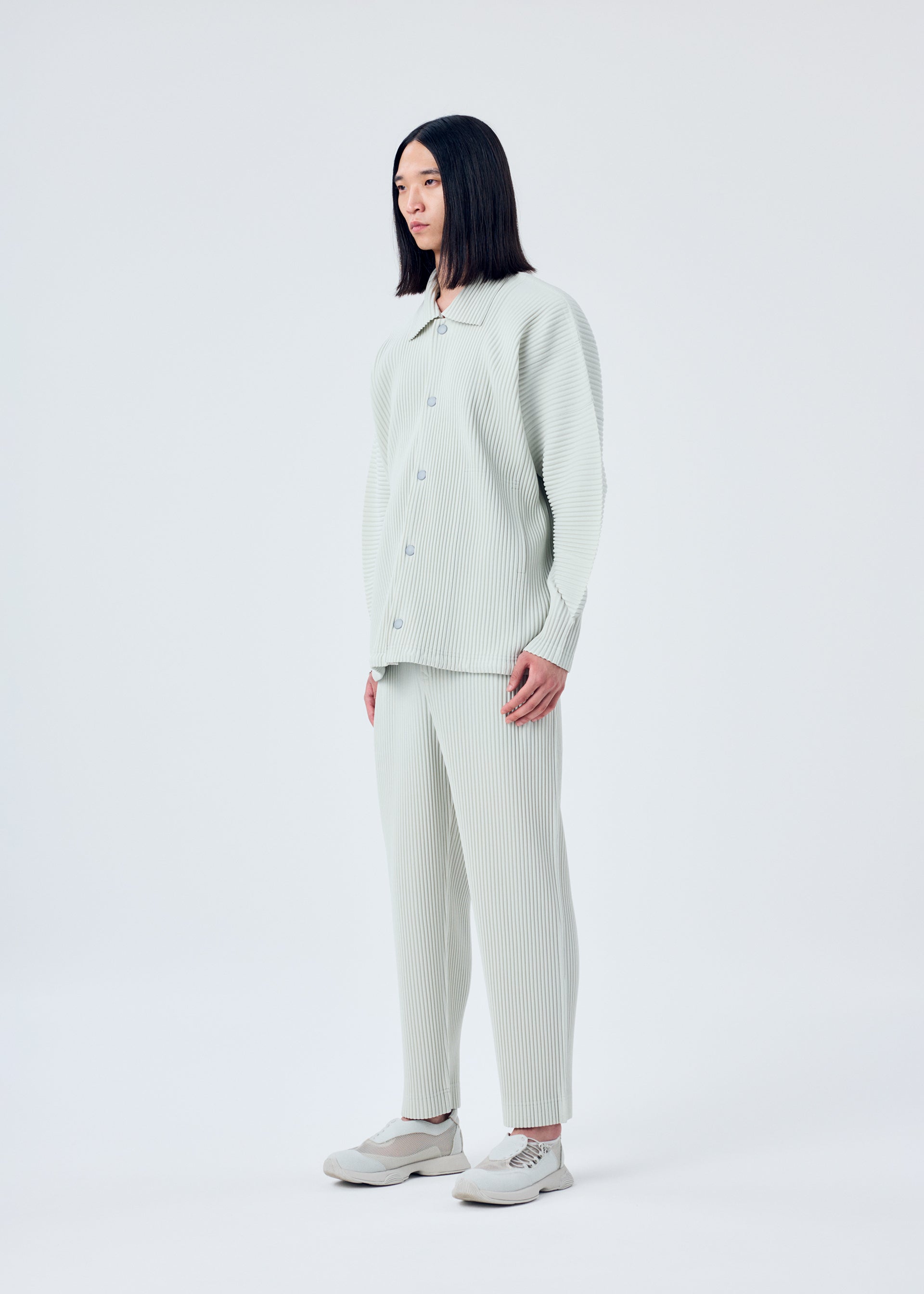 A model wears the HOMME PLISSÉ ISSEY MIYAKE MC MARCH jacket.
