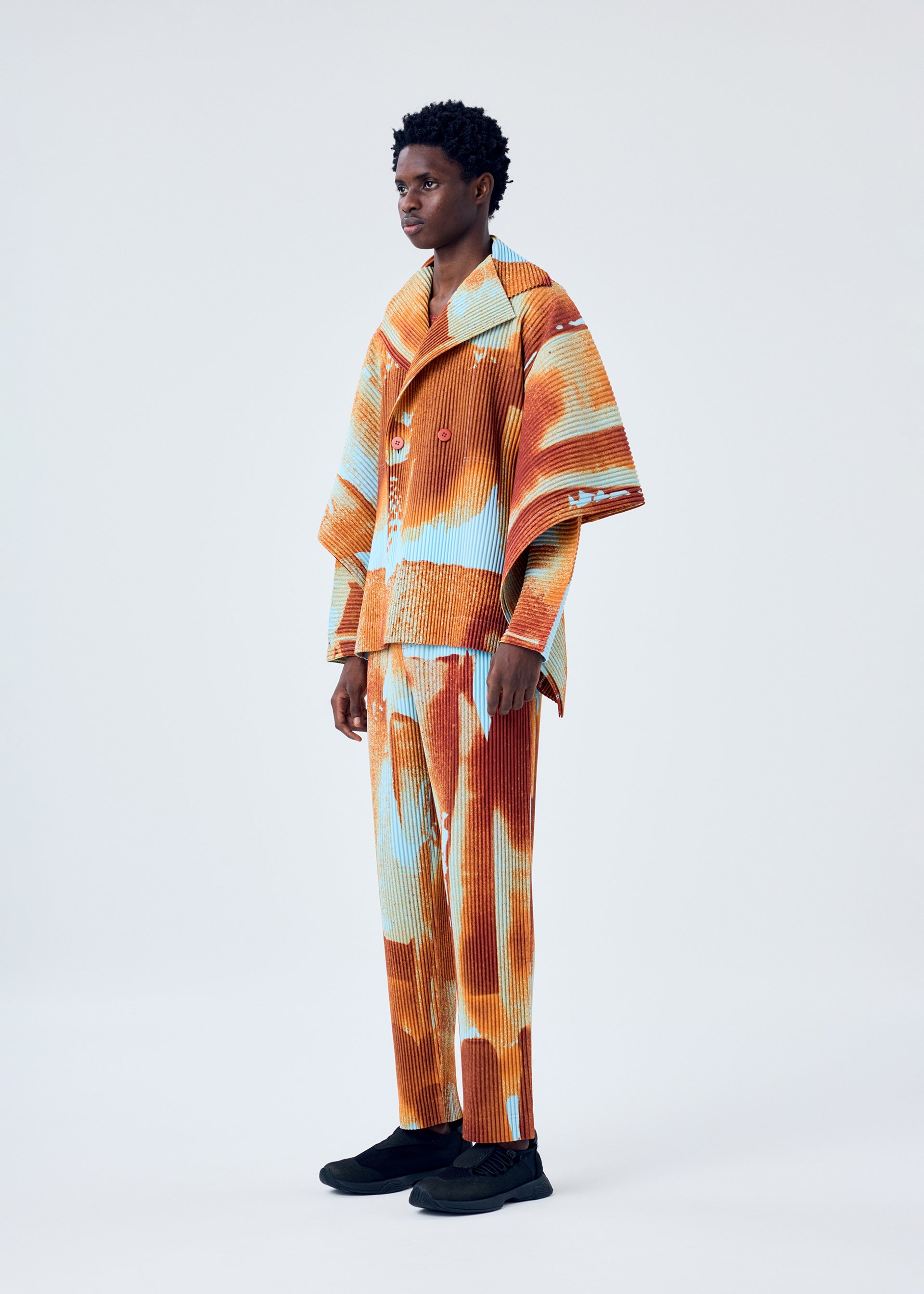 A model wears the HOMME PLISSÉ ISSEY MIYAKE WIND WALK jacket.