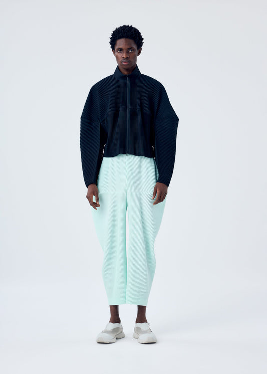 A model wears the HOMME PLISSÉ ISSEY MIYAKE KINETIC SCULPTURE jacket.