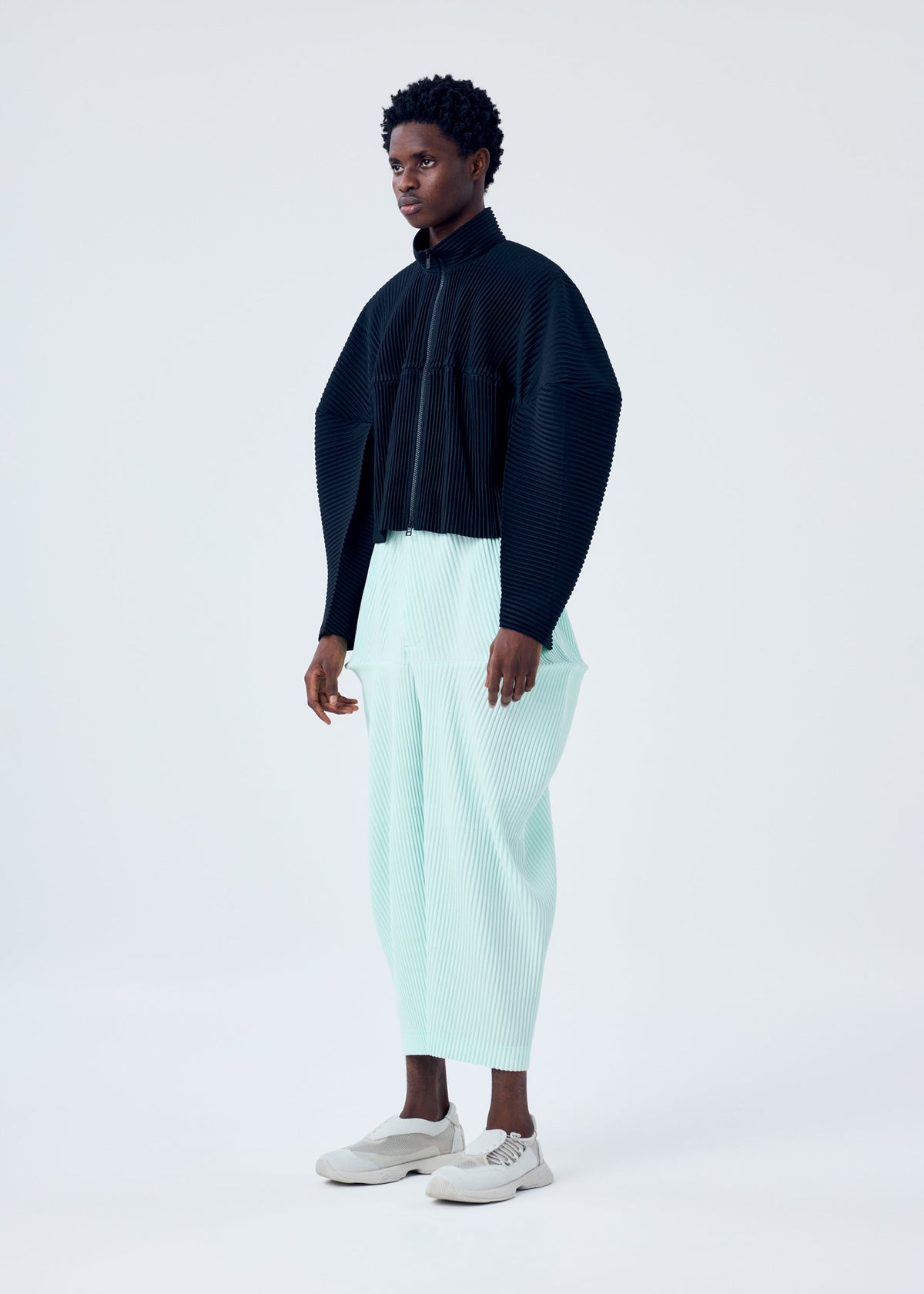 A model wears the HOMME PLISSÉ ISSEY MIYAKE KINETIC SCULPTURE jacket.