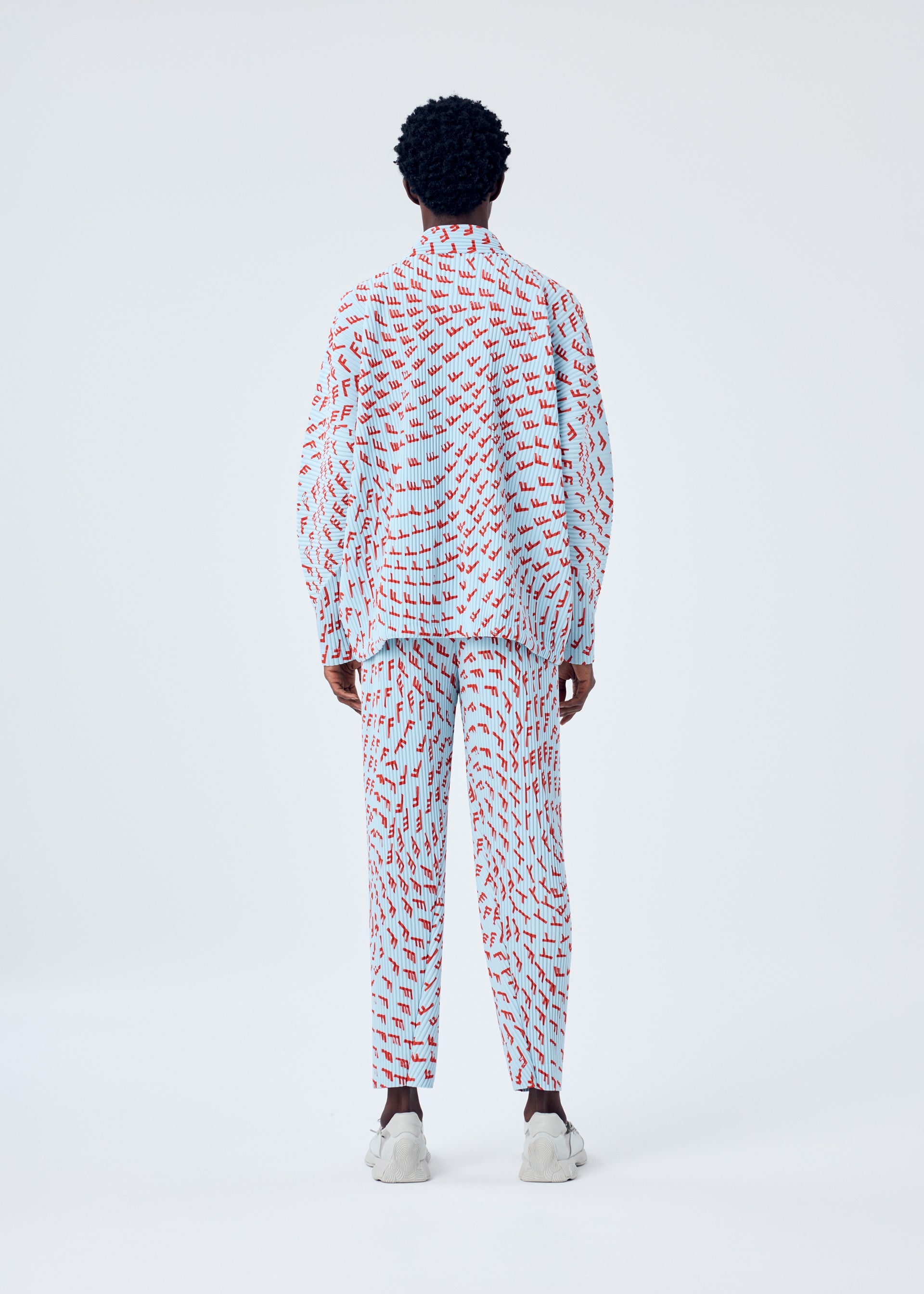 A model wears the HOMME PLISSÉ ISSEY MIYAKE WIND SPEED jacket.