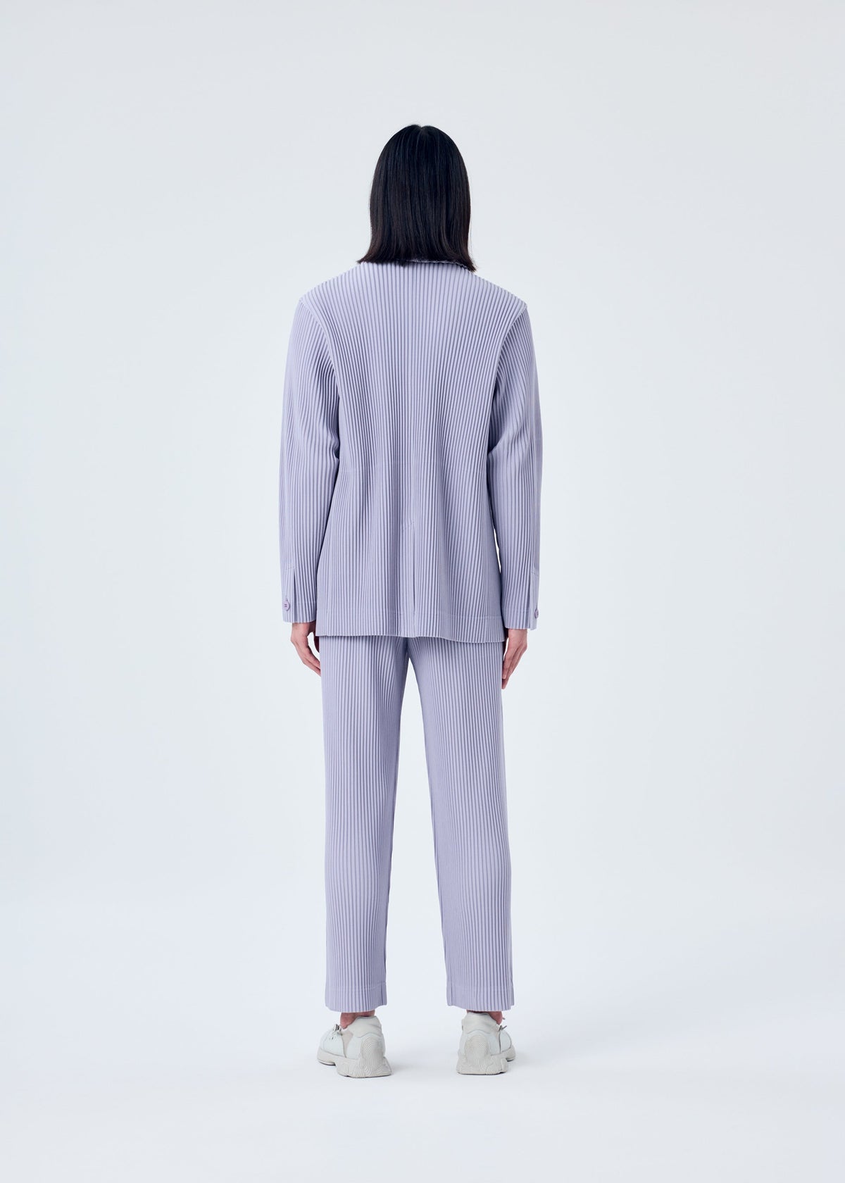 A model wears the HOMME PLISSÉ ISSEY MIYAKE TAILORED PLEATS 2 jacket.