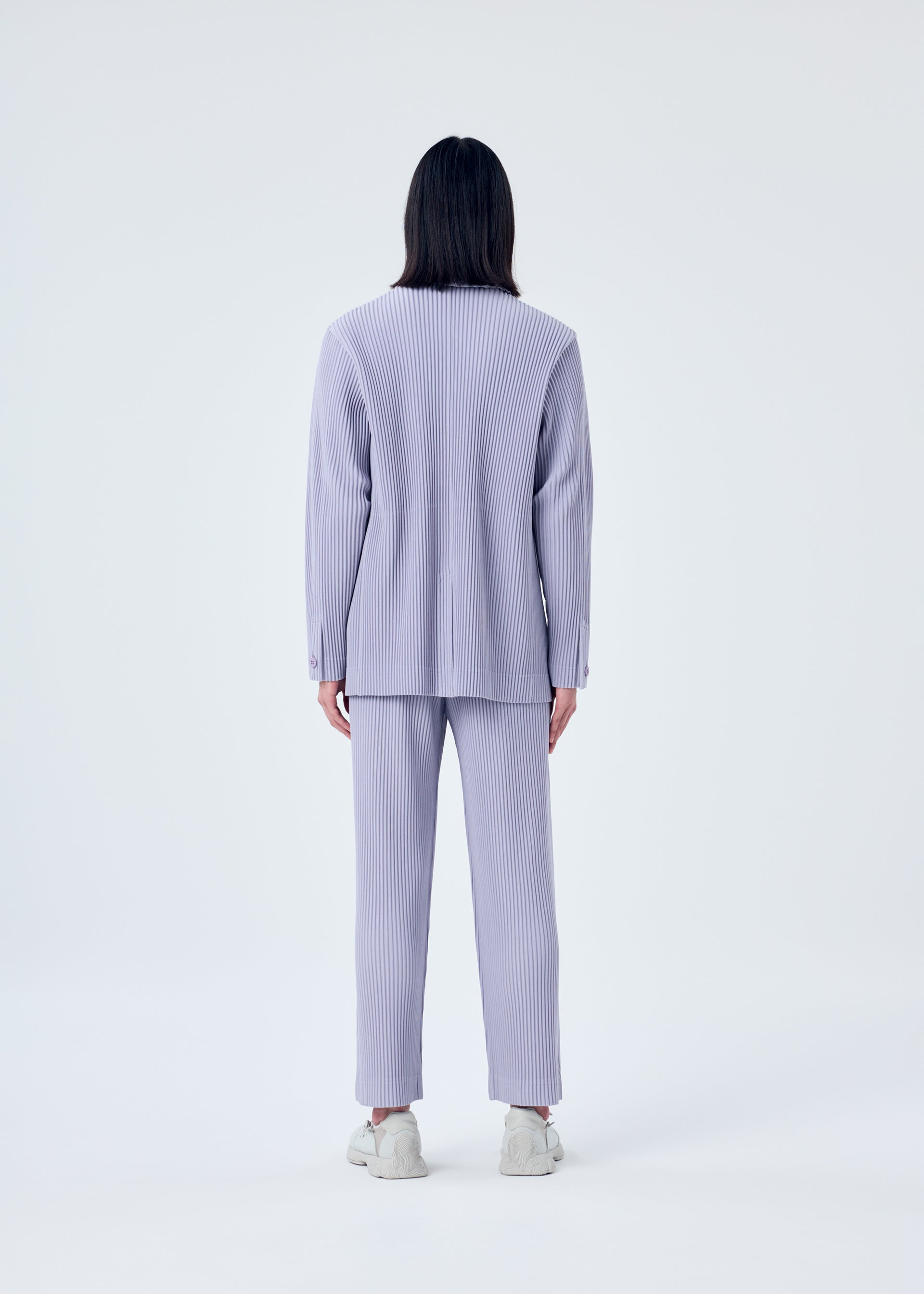 A model wears the HOMME PLISSÉ ISSEY MIYAKE TAILORED PLEATS 2 jacket.