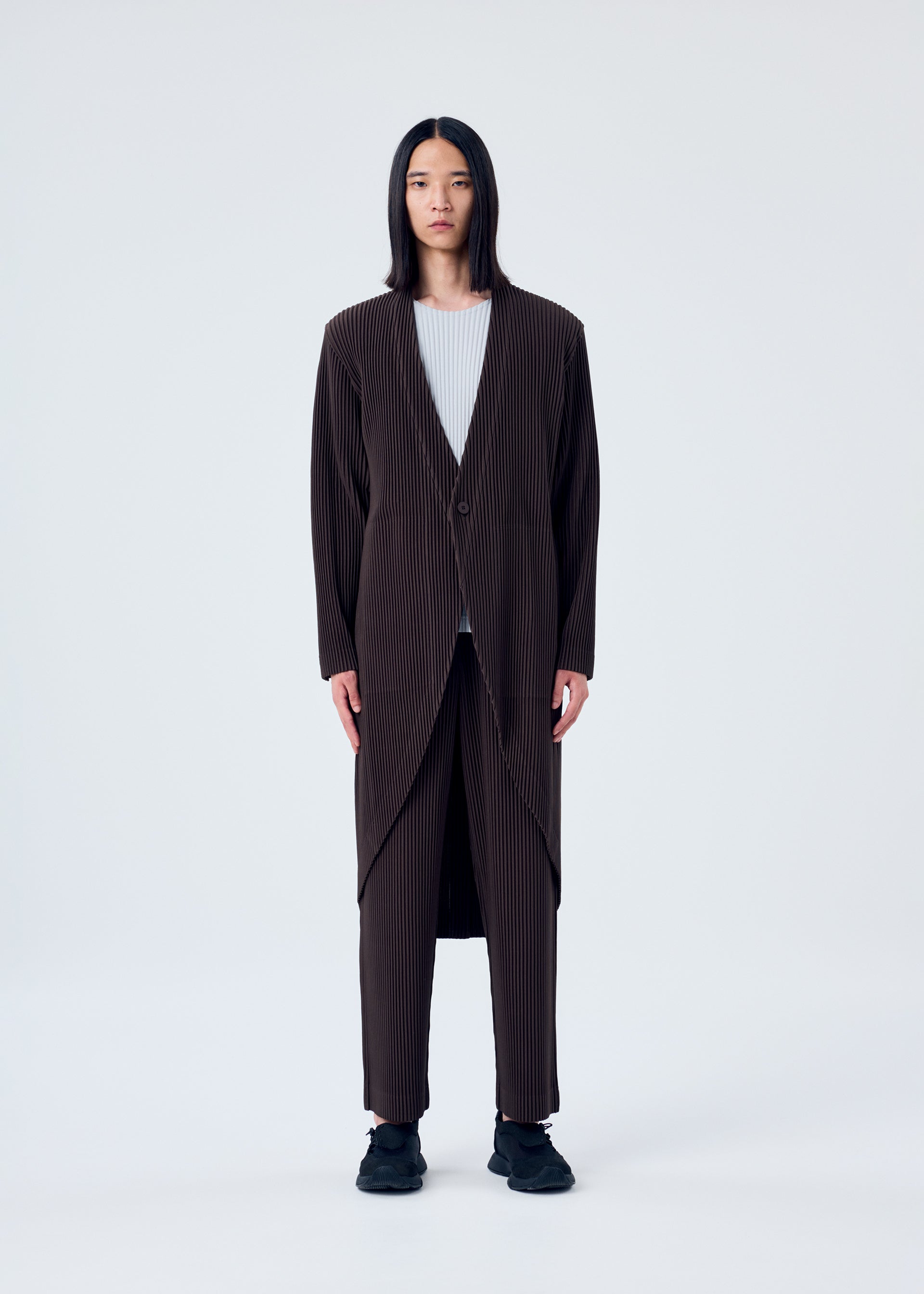 A model wears the HOMME PLISSÉ ISSEY MIYAKE TAILORED PLEATS 2 jacket.