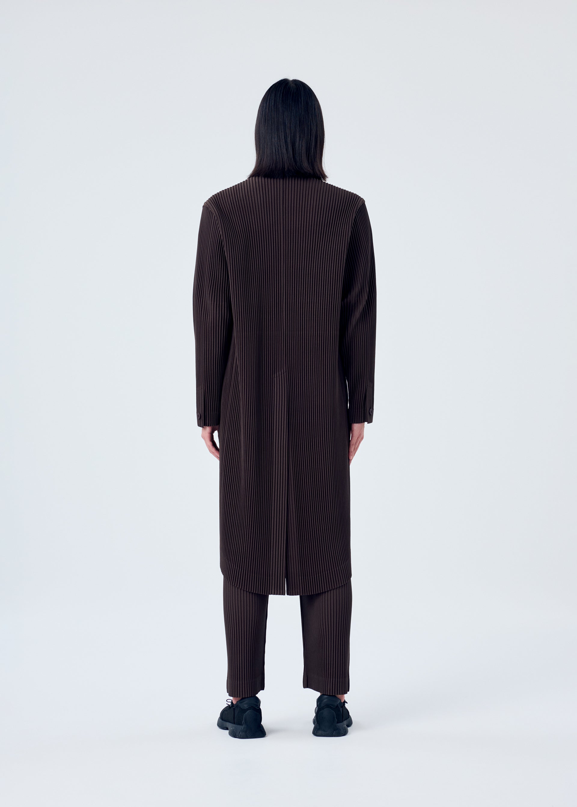 A model wears the HOMME PLISSÉ ISSEY MIYAKE TAILORED PLEATS 2 jacket.
