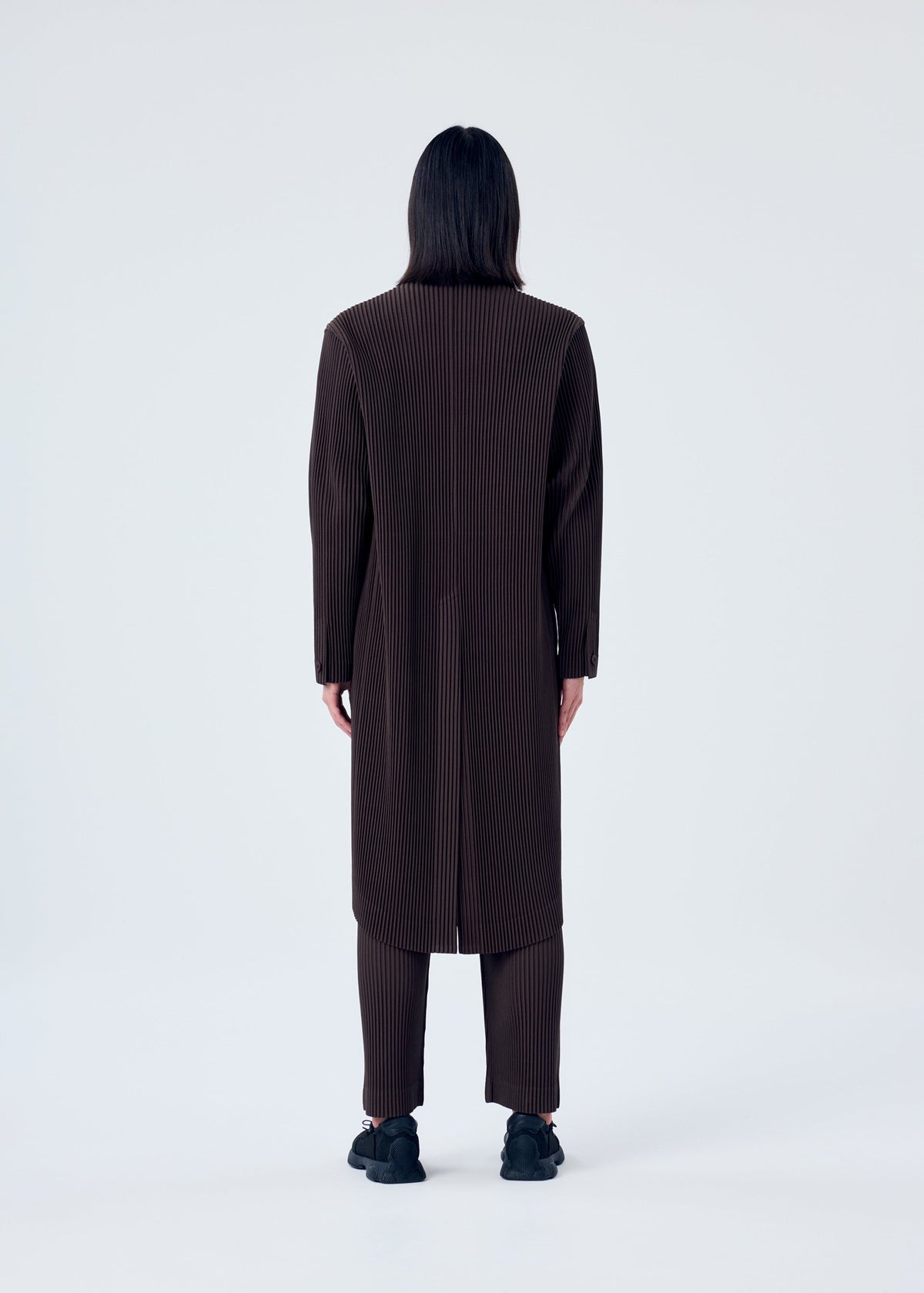 A model wears the HOMME PLISSÉ ISSEY MIYAKE TAILORED PLEATS 2 jacket.