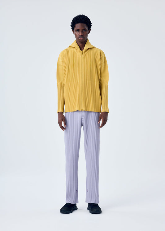 A model wears the HOMME PLISSÉ ISSEY MIYAKE MC JUNE trousers.