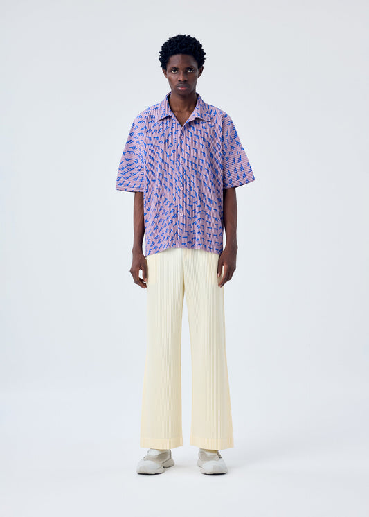 A model wears the HOMME PLISSÉ ISSEY MIYAKE PLEATS BOTTOMS 3 trousers.