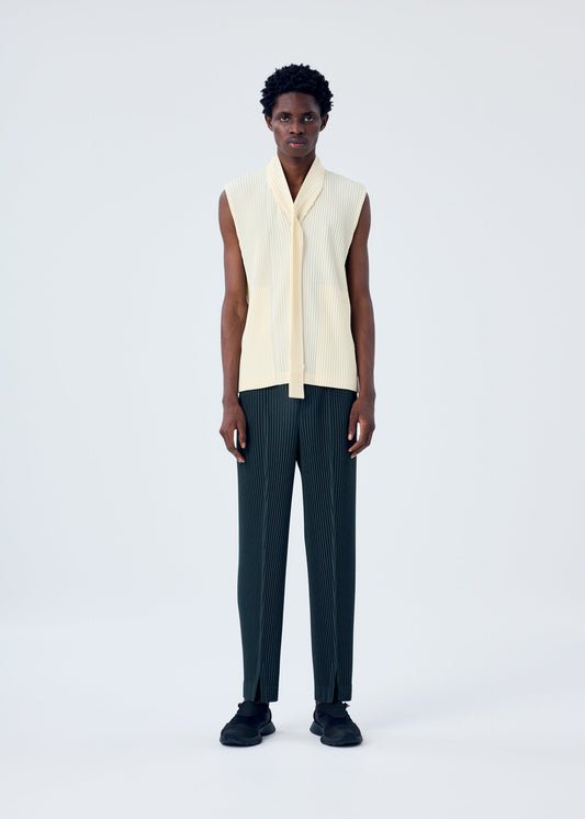 A model wears the HOMME PLISSÉ ISSEY MIYAKE PLEATS BOTTOMS 2 trousers.
