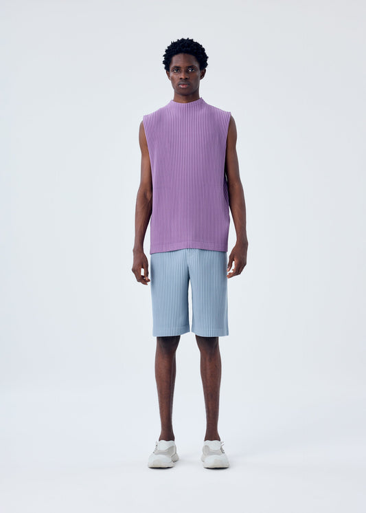 A model wears the HOMME PLISSÉ ISSEY MIYAKE COLOR PLEATS trousers.
