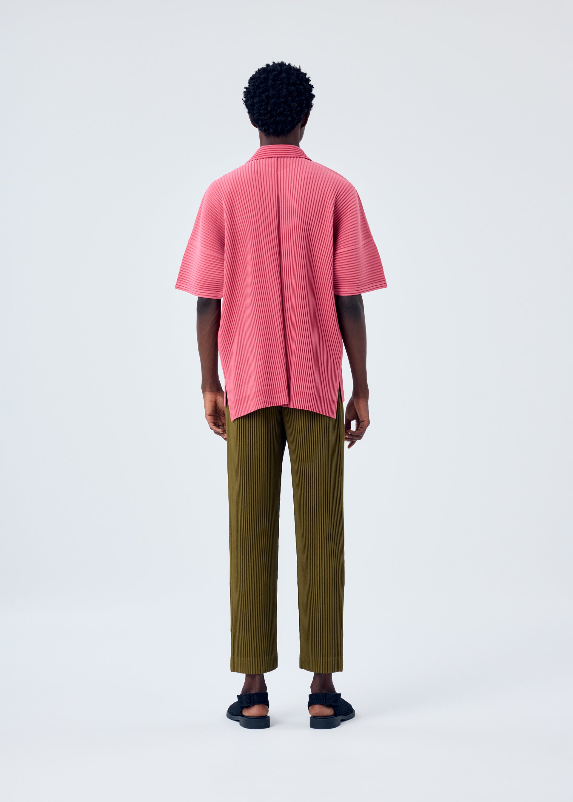 A model wears the HOMME PLISSÉ ISSEY MIYAKE MC APRIL shirt.