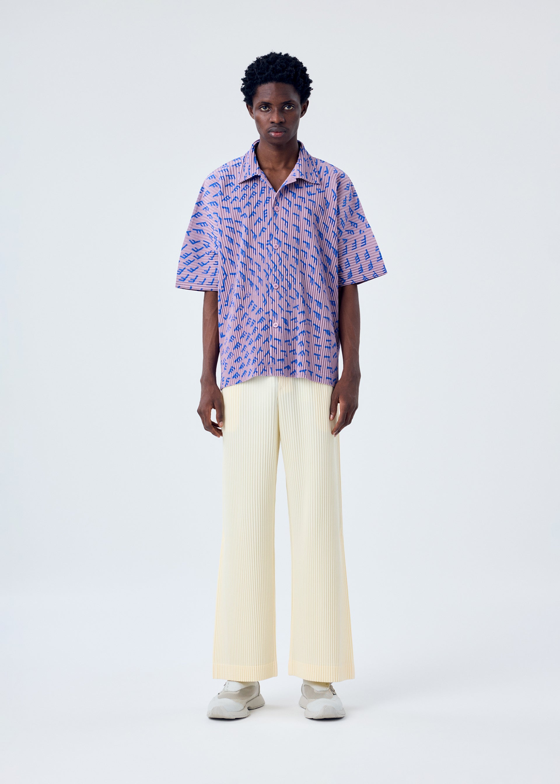 A model wears the HOMME PLISSÉ ISSEY MIYAKE WIND SPEED shirt.