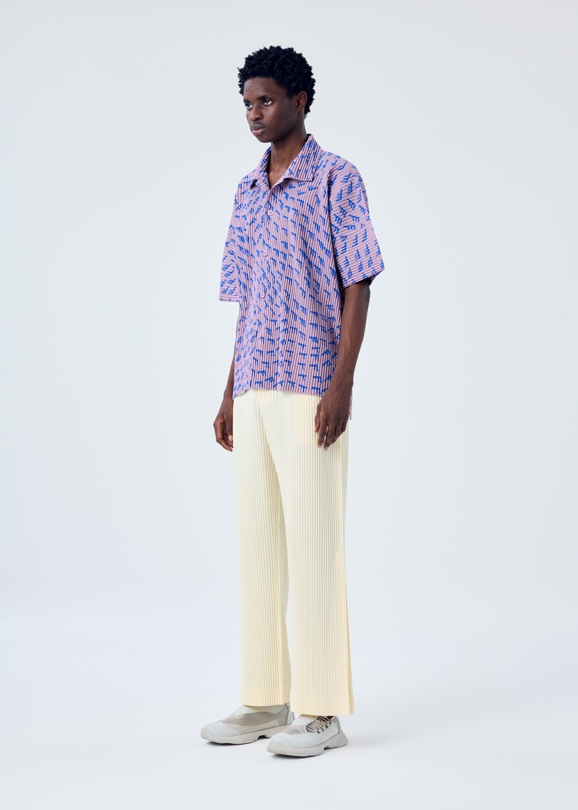 A model wears the HOMME PLISSÉ ISSEY MIYAKE WIND SPEED shirt.