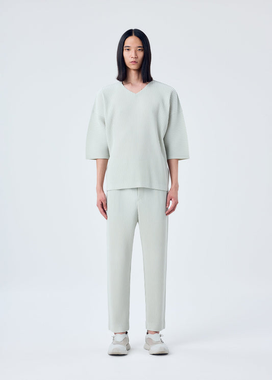 A model wears the HOMME PLISSÉ ISSEY MIYAKE MC MARCH top.