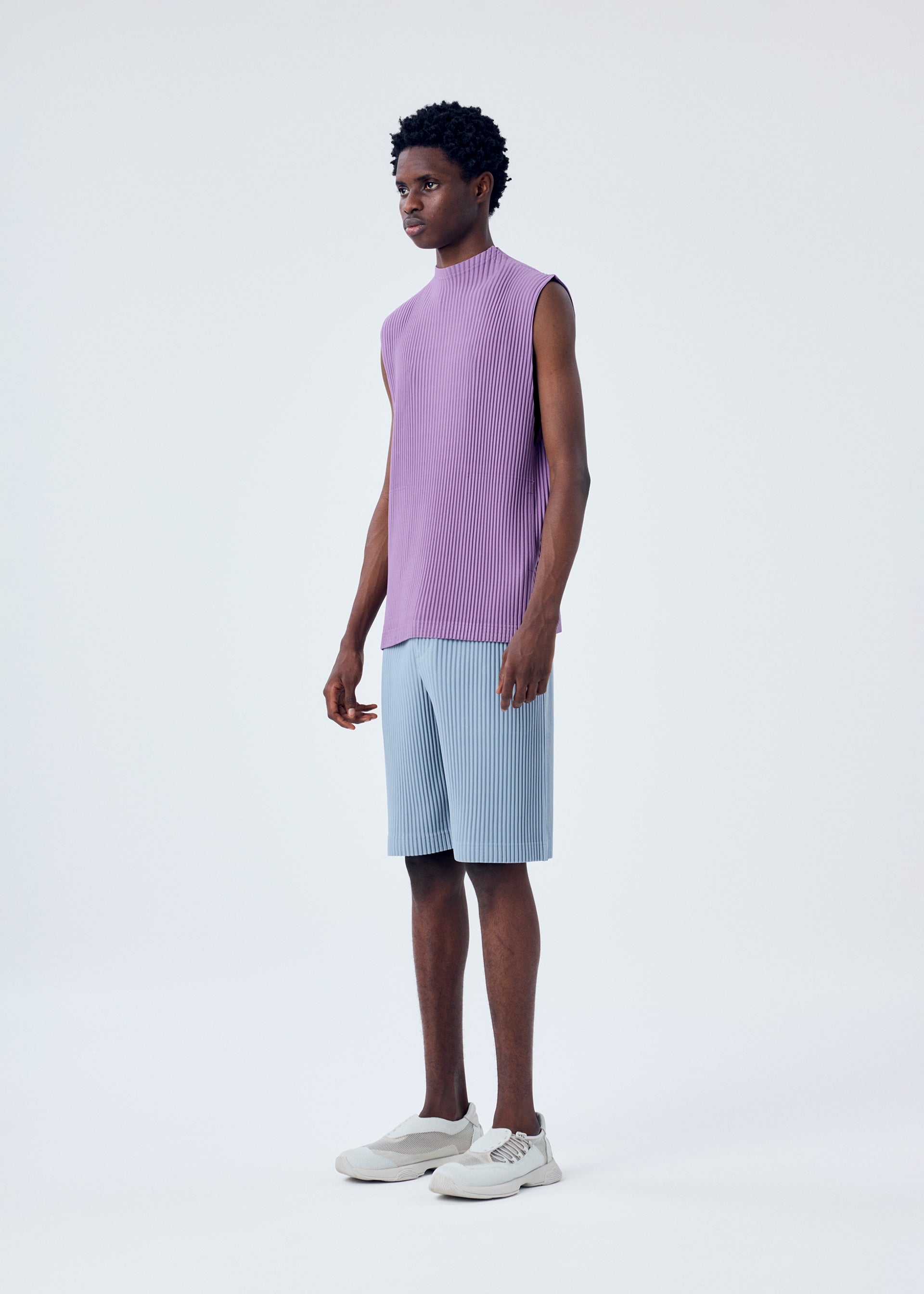 A model wears the HOMME PLISSÉ ISSEY MIYAKE MC APRIL top.