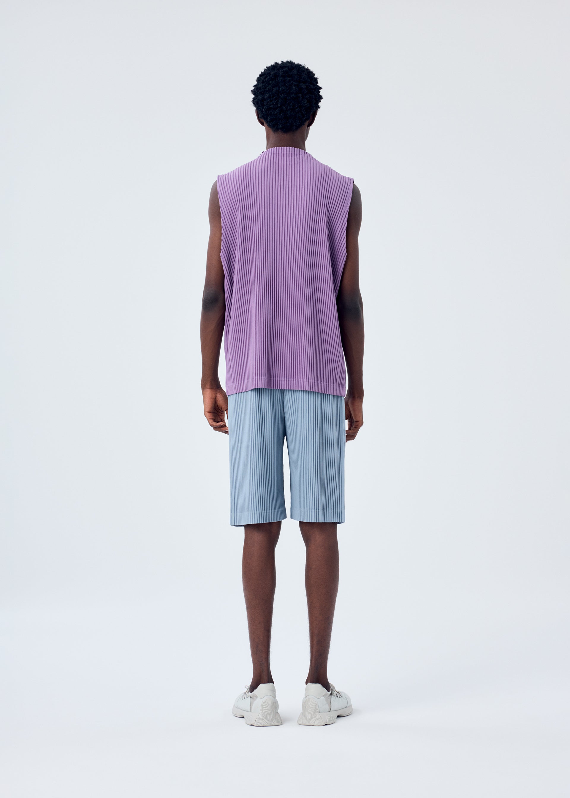 A model wears the HOMME PLISSÉ ISSEY MIYAKE MC APRIL top.