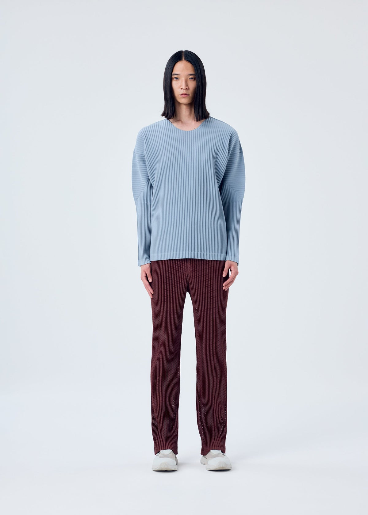 A model wears the HOMME PLISSÉ ISSEY MIYAKE COLOR PLEATS top.