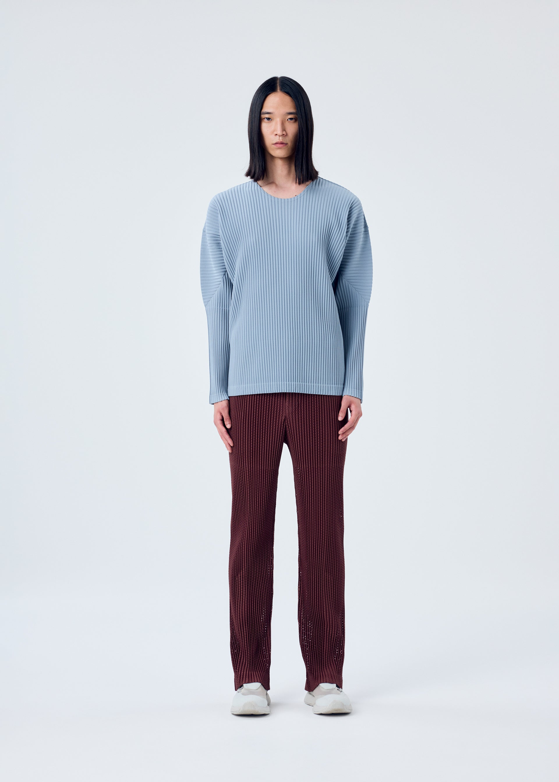 A model wears the HOMME PLISSÉ ISSEY MIYAKE COLOR PLEATS top.