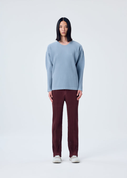 A model wears the HOMME PLISSÉ ISSEY MIYAKE COLOR PLEATS top.