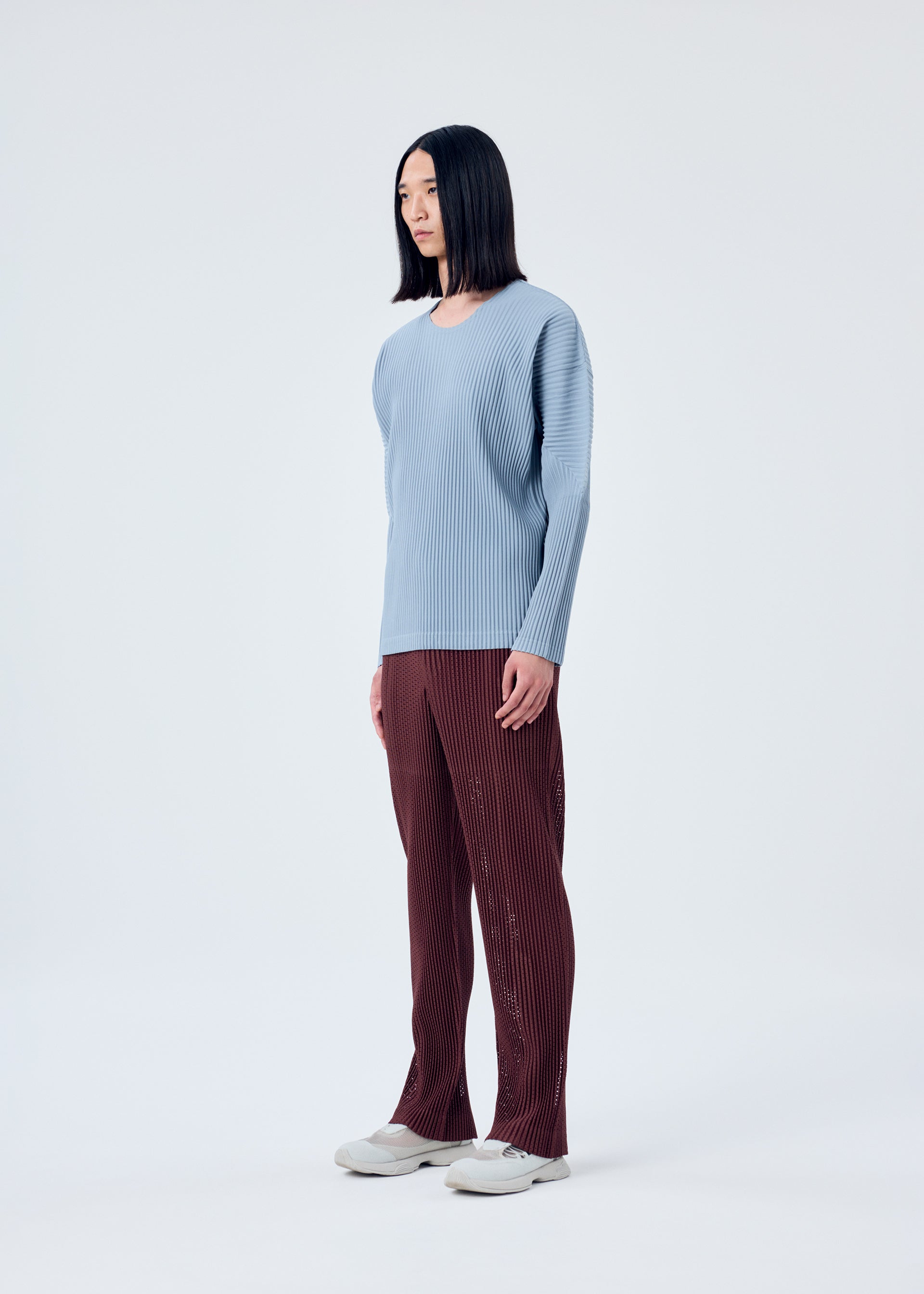 A model wears the HOMME PLISSÉ ISSEY MIYAKE COLOR PLEATS top.