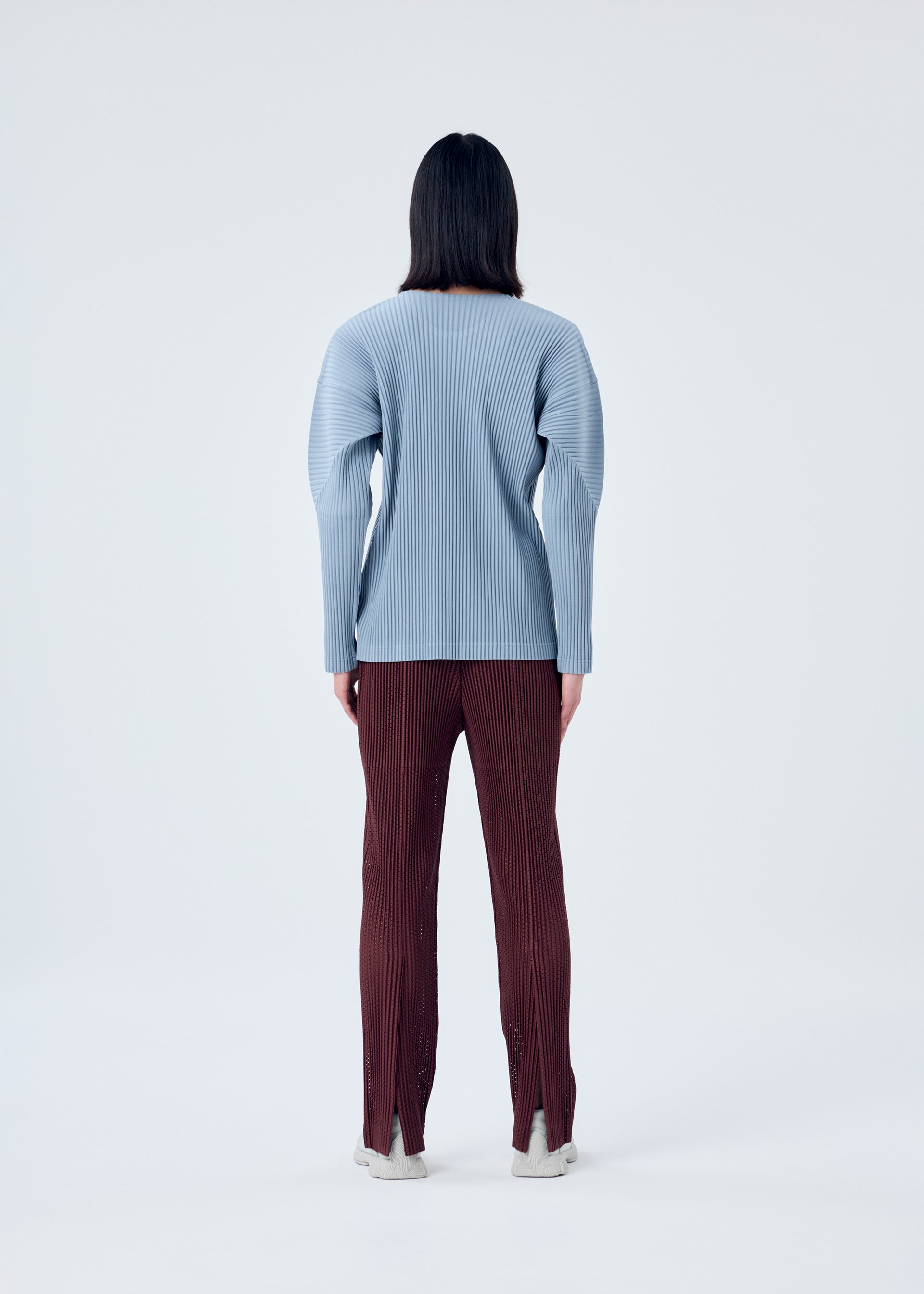 A model wears the HOMME PLISSÉ ISSEY MIYAKE COLOR PLEATS top.
