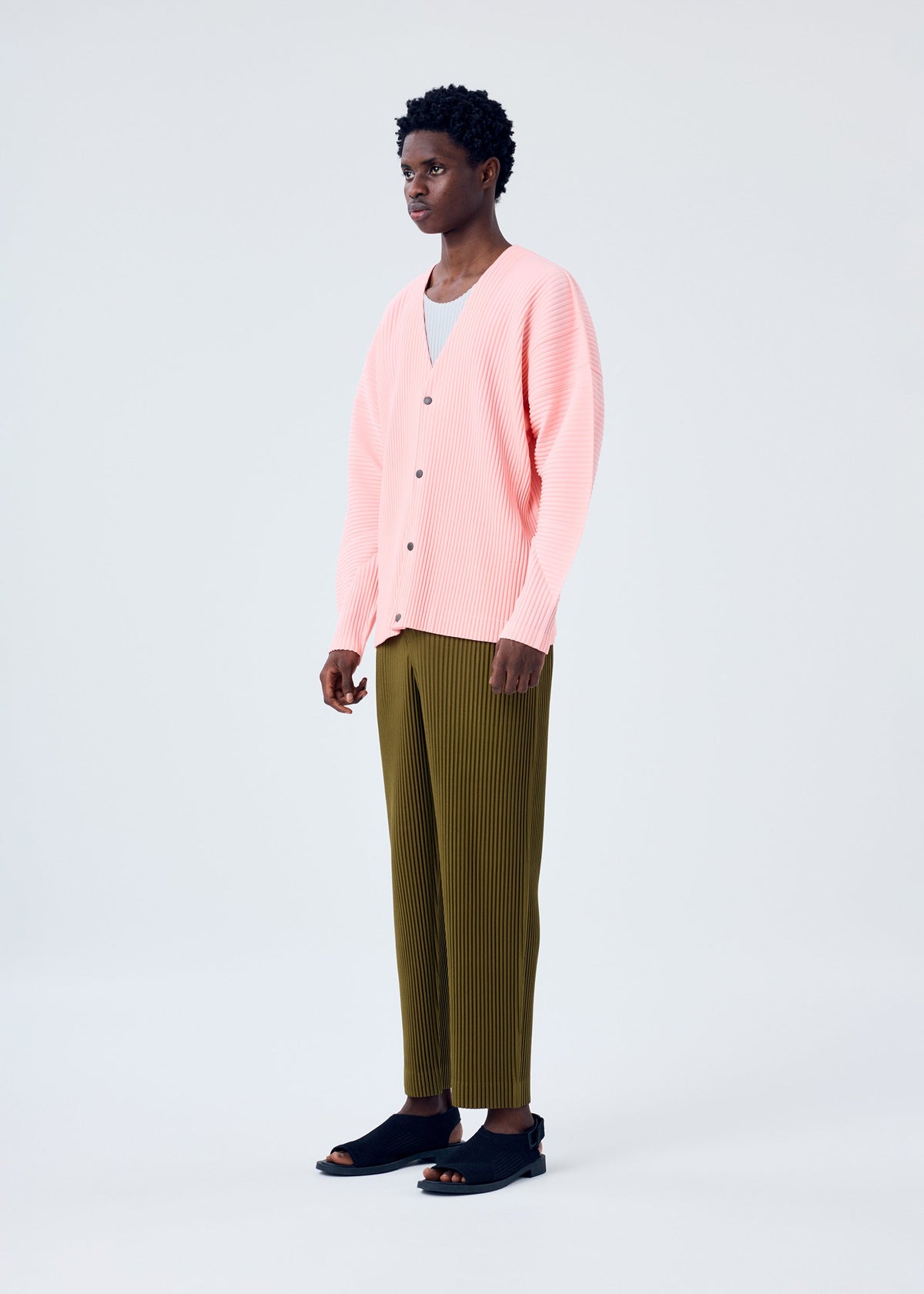 A model wears the HOMME PLISSÉ ISSEY MIYAKE MC APRIL shirt.