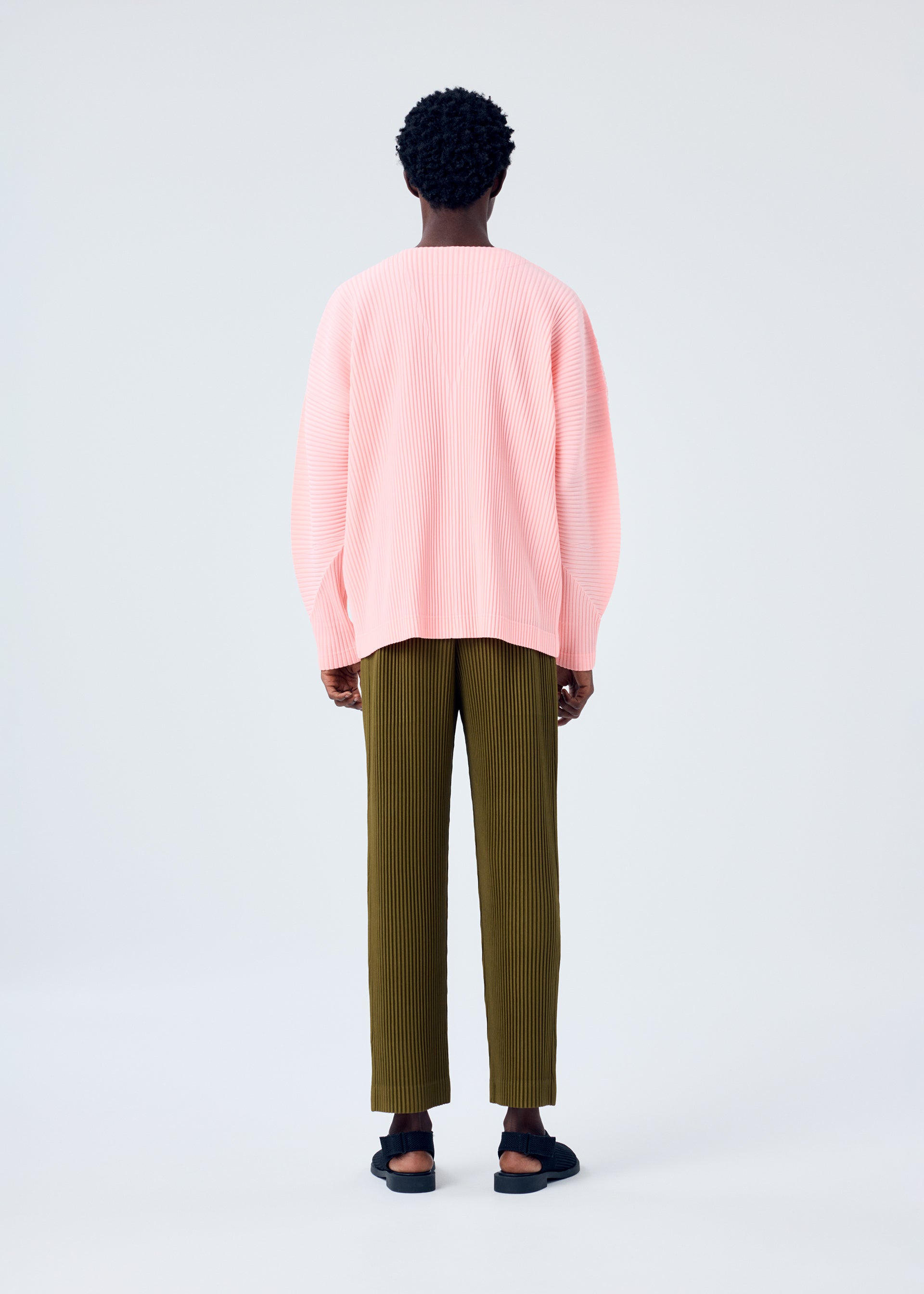 A model wears the HOMME PLISSÉ ISSEY MIYAKE MC APRIL shirt.