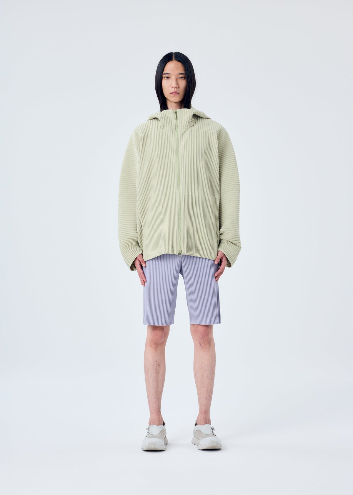 A model wears the HOMME PLISSÉ ISSEY MIYAKE MC MAY shirt.