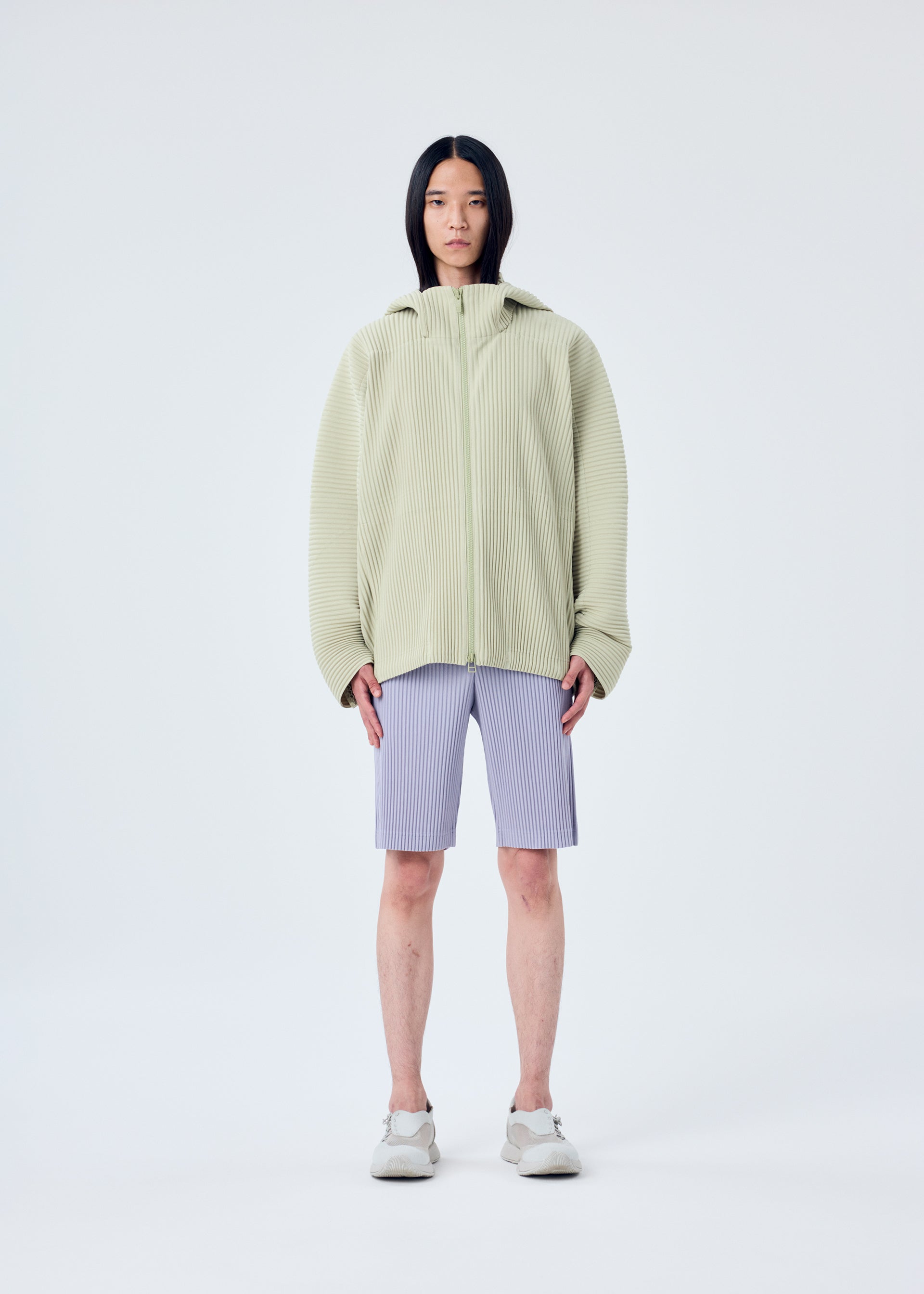 A model wears the HOMME PLISSÉ ISSEY MIYAKE MC MAY shirt.