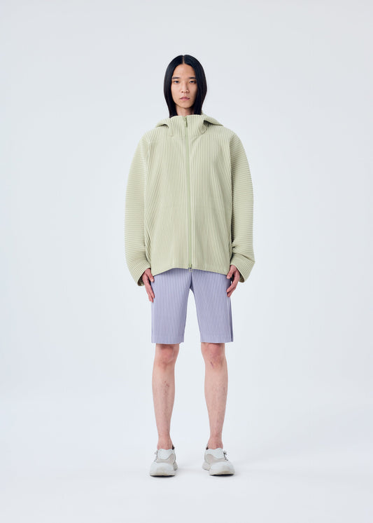 A model wears the HOMME PLISSÉ ISSEY MIYAKE MC MAY shirt.