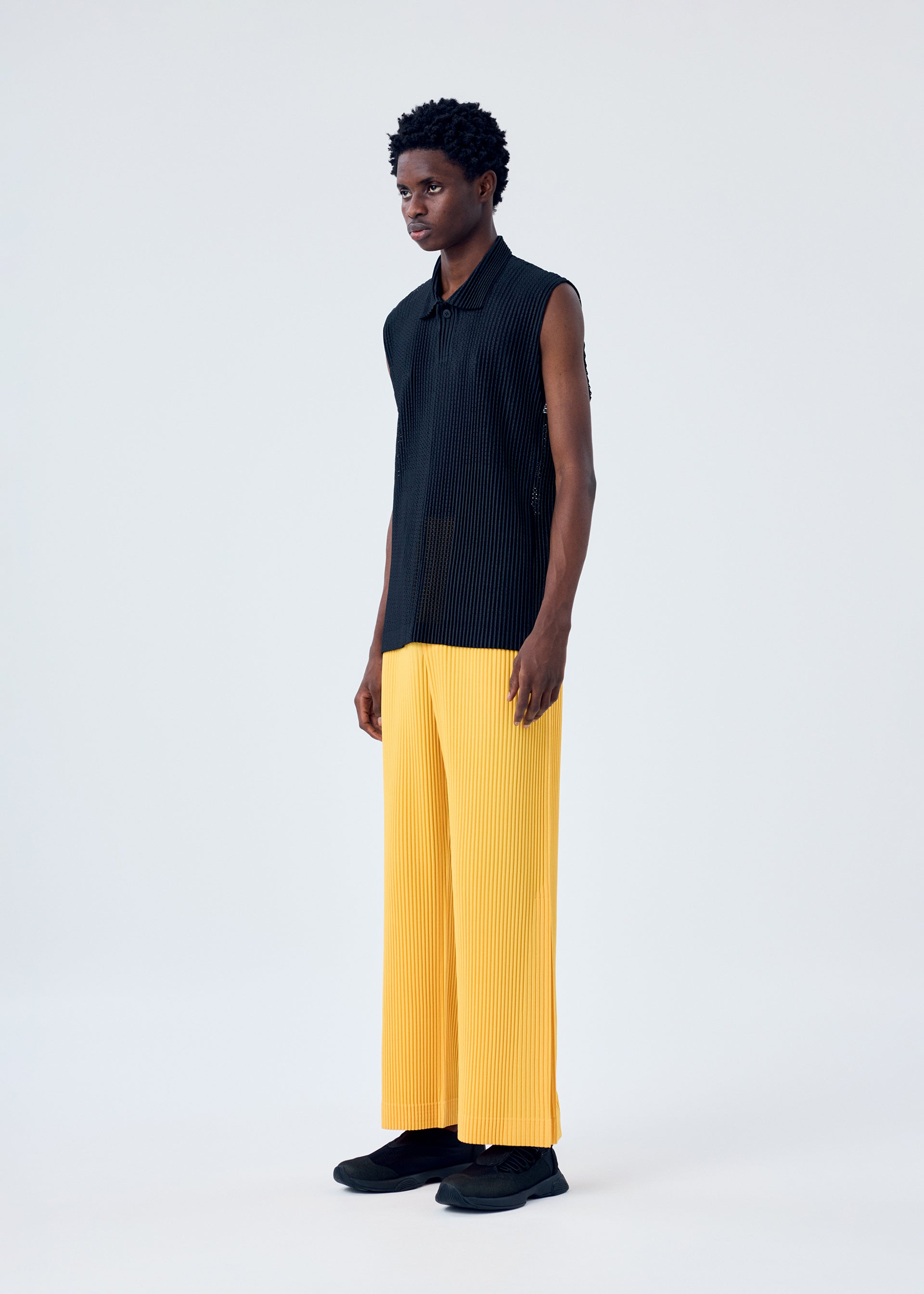 A model wears the HOMME PLISSÉ ISSEY MIYAKE LIGHT MESH shirt.