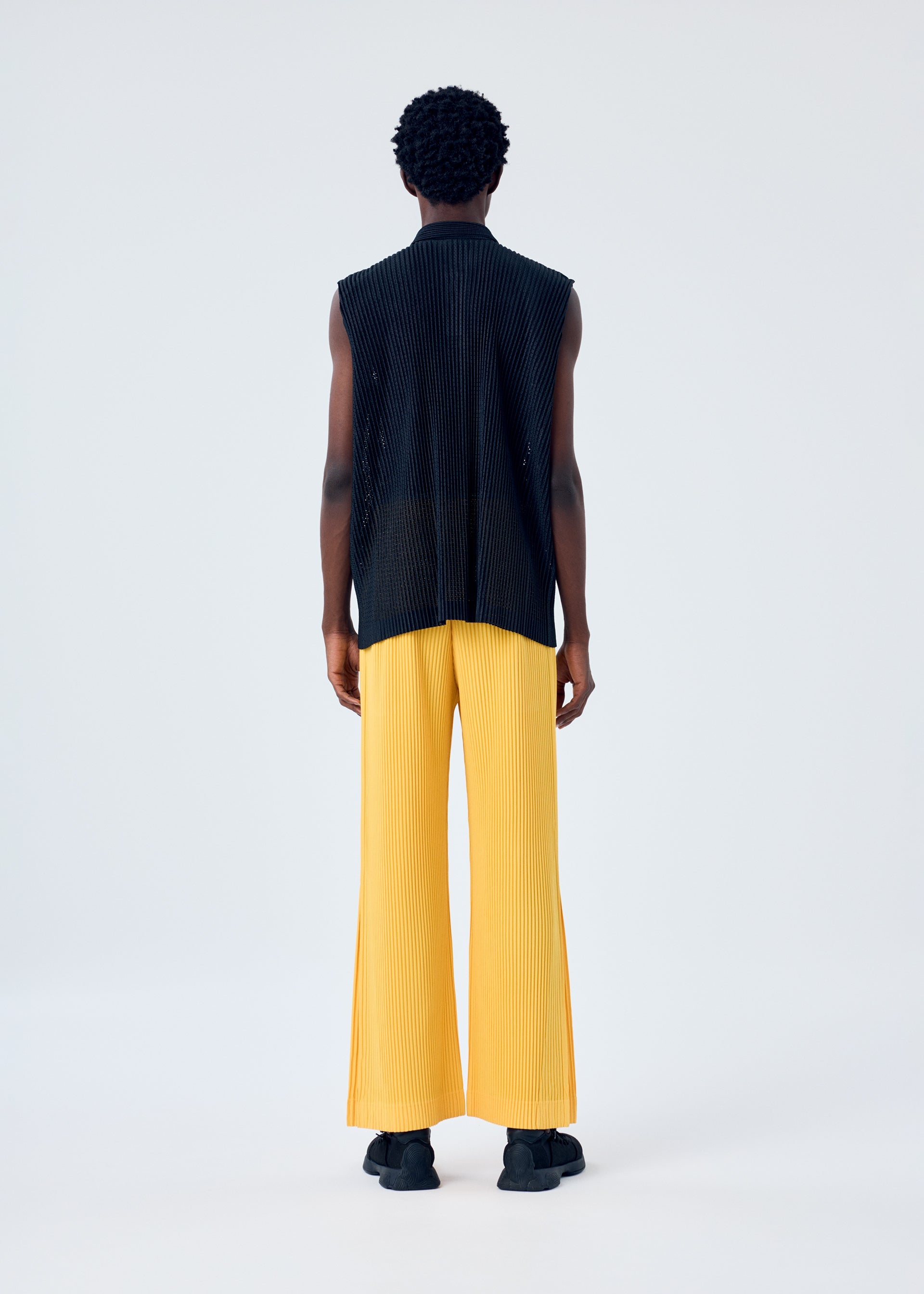 A model wears the HOMME PLISSÉ ISSEY MIYAKE LIGHT MESH shirt.